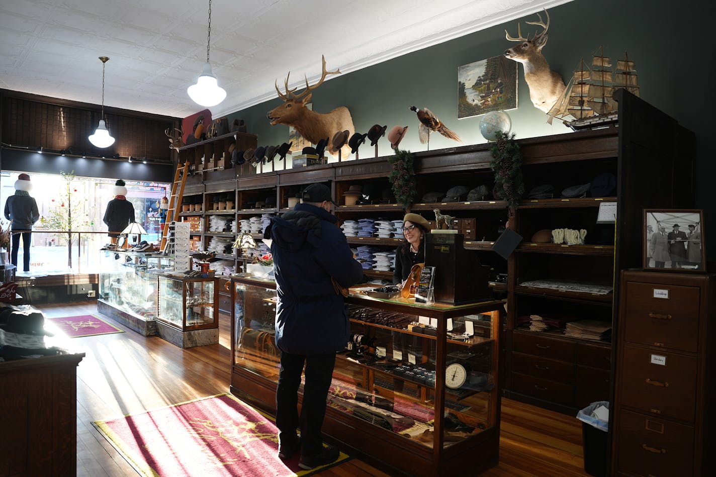 Mickey Martin talks with a customer at Heimie's Haberdashery Tuesday, Nov. 28, 2023 in Red Wing, Minn. ] ANTHONY SOUFFLE • anthony.souffle@startribune.com