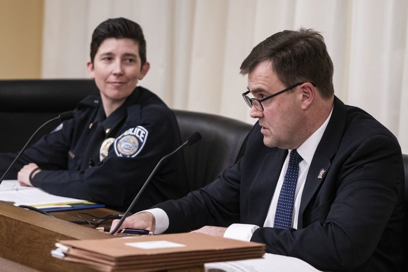 Left: Kelly McCarthy, chair of the POST Board and police chief of Mendota Height and POST Board interim executive director Erik Misselt testified Thursday afternoon at the state legislature.