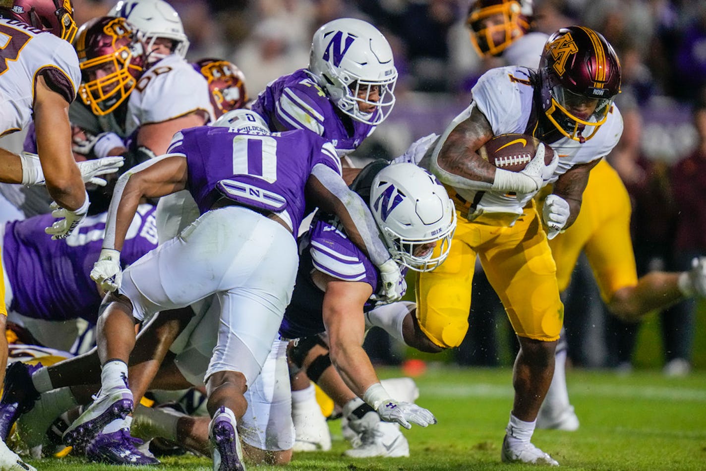 Minnesota running back Darius Taylor, right, fights his way into the end zone for a touchdown against Northwestern during the first half of an NCAA college football game Saturday, Sept. 23, 2023, in Evanston, Ill. (AP Photo/Erin Hooley)