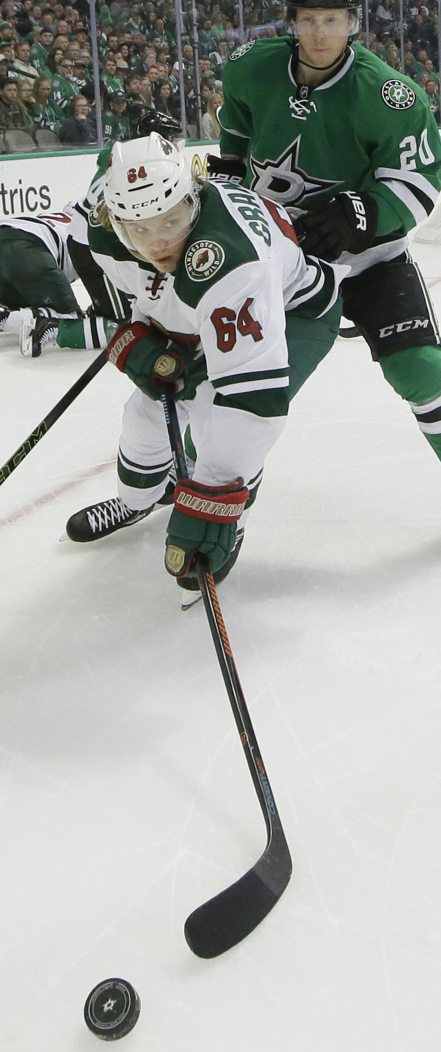 Minnesota Wild center Mikael Granlund (64) reaches for the puck against Dallas Stars center Cody Eakin (20) during the second period in Game 2 in the first round of the NHL Stanley Cup playoffs Saturday, April 16, 2016, in Dallas. (AP Photo/LM Otero)