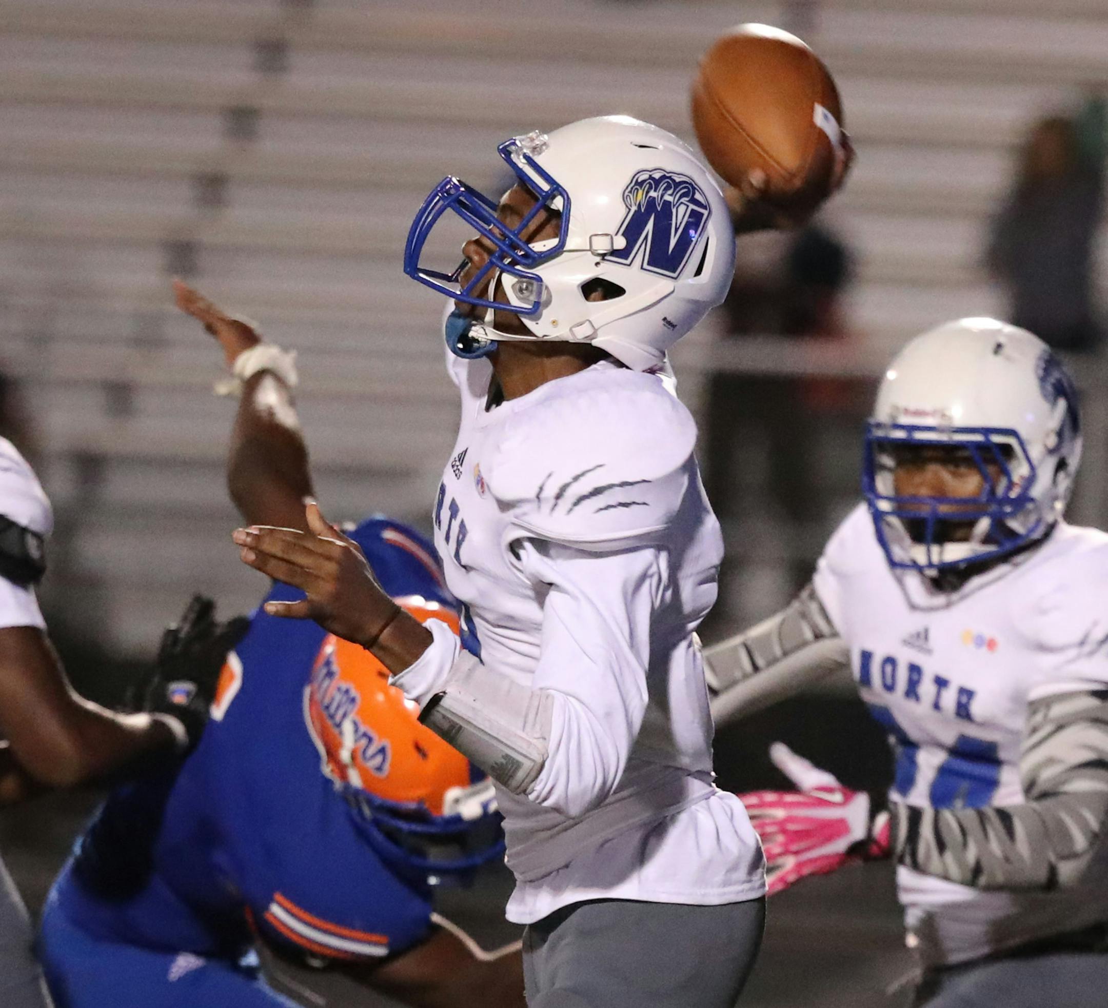 With pressure on Minneapolis North quarterback Armon Dalton (9) fires a TD pass downfield to receiver Nasir El-Amin, giving North a 22-15 win at Washburn Friday, Sept. 2, 2016, in Minneapolis, MN.(DAVID JOLES/STARTRIBUNE)djoles@ Mpls North at Washburn