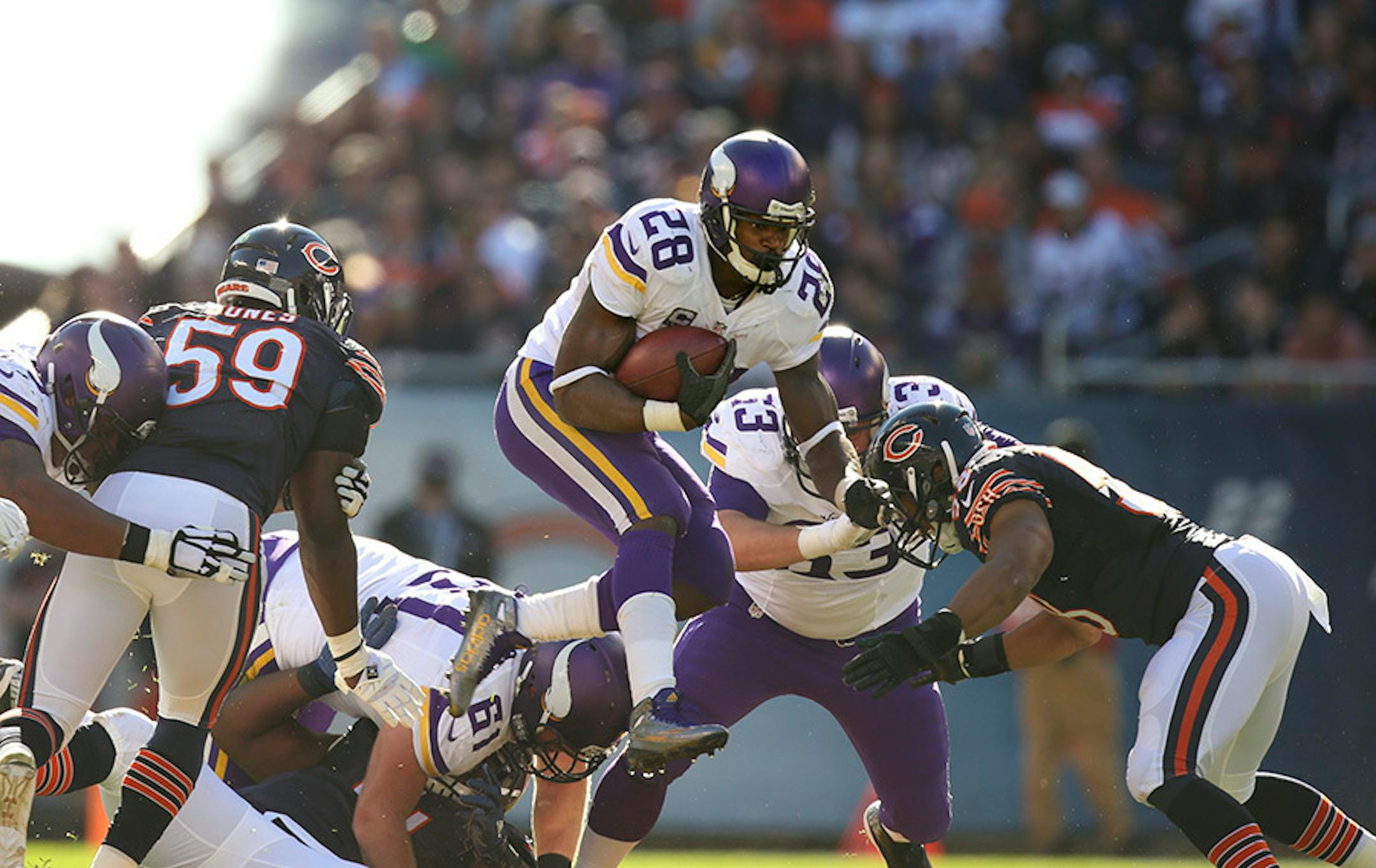 Vikings running back Adrian Peterson (28) with a second quarter gain Sunday afternoon.