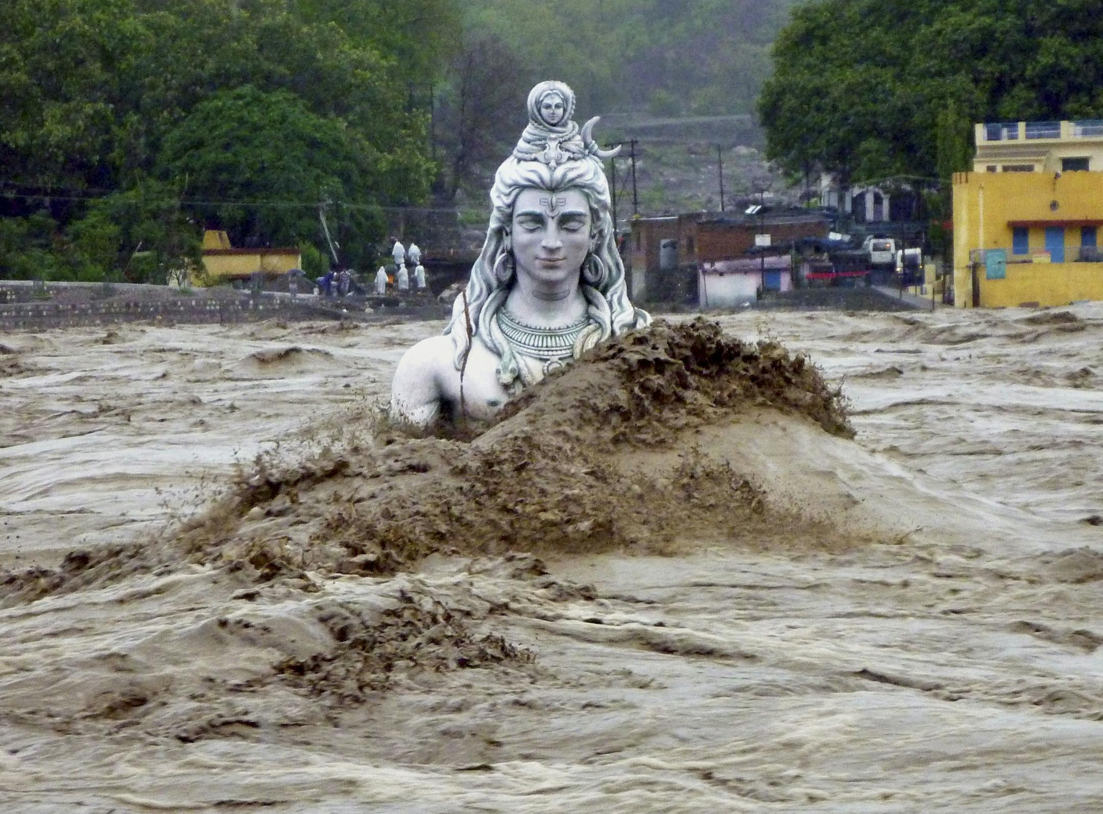 A submerged idol of Hindu Lord Shiva stands in the flooded River Ganges in Rishikesh, in the northern Indian state of Uttarakhand, India, Tuesday, June 18, 2013. Monsoon torrential rains have cause havoc in northern India leading to flash floods, cloudbursts and landslides as the death toll continues to climb and more than 1,000 pilgrims bound for Himalayan shrines remain stranded.