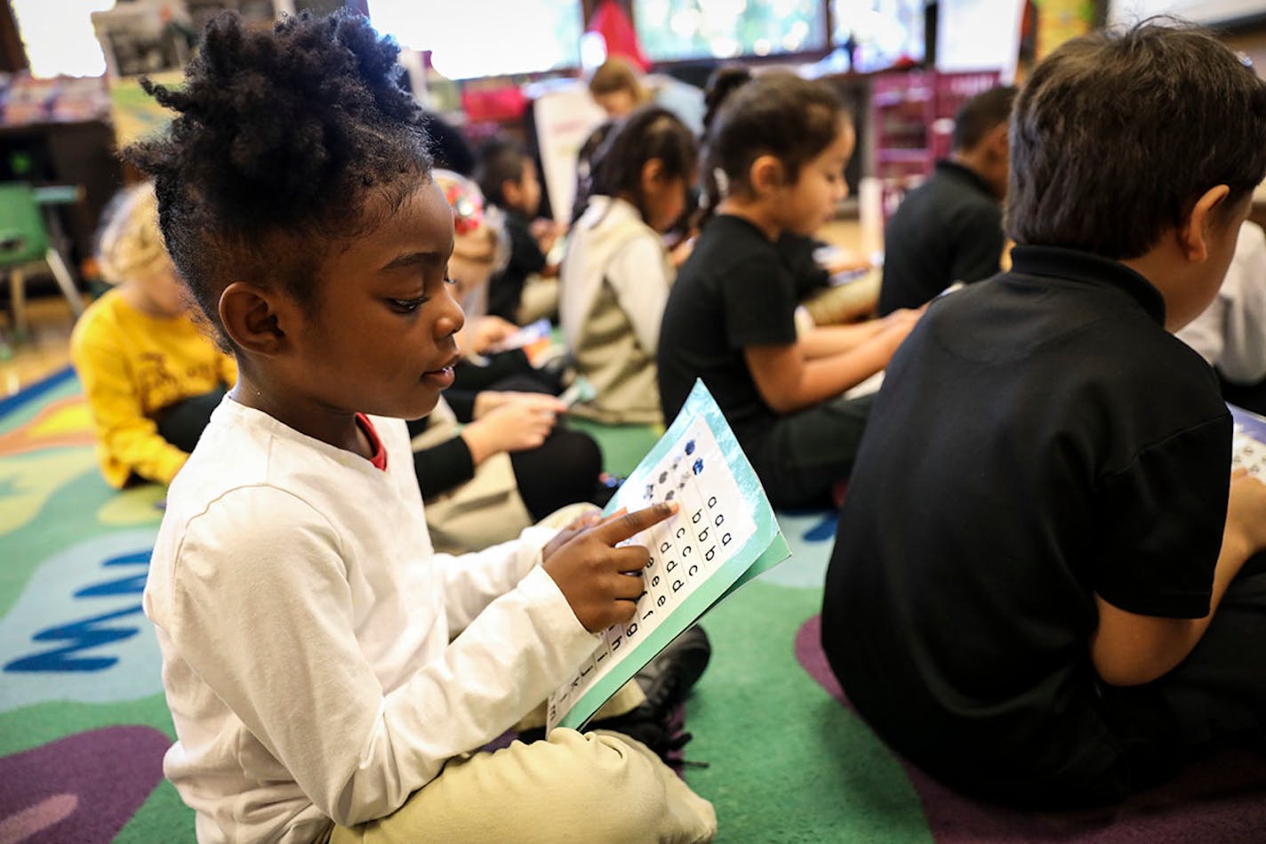 Kindergartener Cedrianna read her letters along with her classmates in David Boucher's class at Folwell School, Performing Arts Magnet School on Tuesday, October 18, 2016, in Minneapolis, Minn.