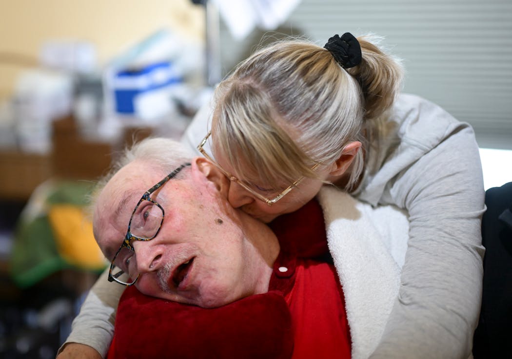 Gloria Hoffman kisses her brother, Glenn Berland, during a visit Friday, March 15, 2024 in Coon Rapids, Minn. Berland was seriously injured in a car accident when he was 17 and has been living in the Magnolia Home since 1990.