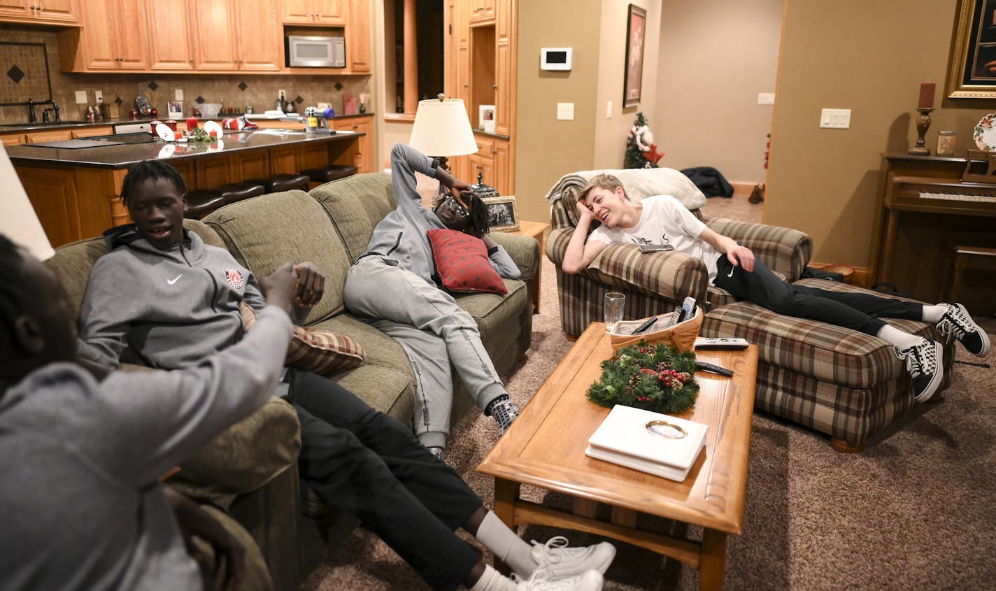 From left, Austin teammates Dieth Duop, Ochan Obany and Agwa Nywesh hung out in the living room of friend and teammate, Jordan Ransom, before they left for a game against John Marshall in late December. ] Aaron Lavinsky &#x2022; aaron.lavinsky@startribune.com Photos to accompany a feature on the ethnic diversification of Austin Minn., as seen through the Austin High School boys basketball and soccer programs, photographed Tuesday, Dec. 17, 2019.