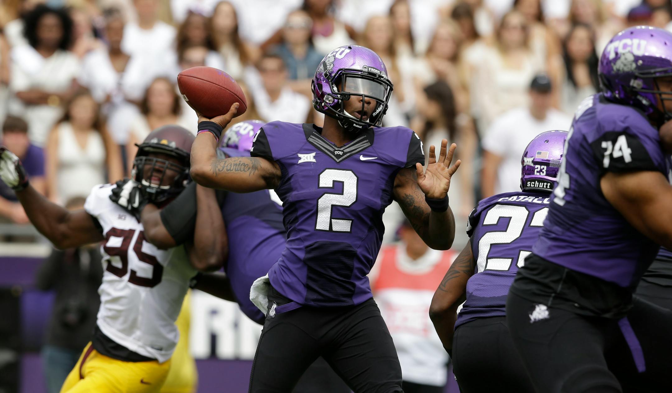 TCU quarterback Trevone Boykin (2) passes the ball as Minnesota defensive lineman Hank Ekpe (95) is blocked when the Gophers and Horned Frogs played in 2014.