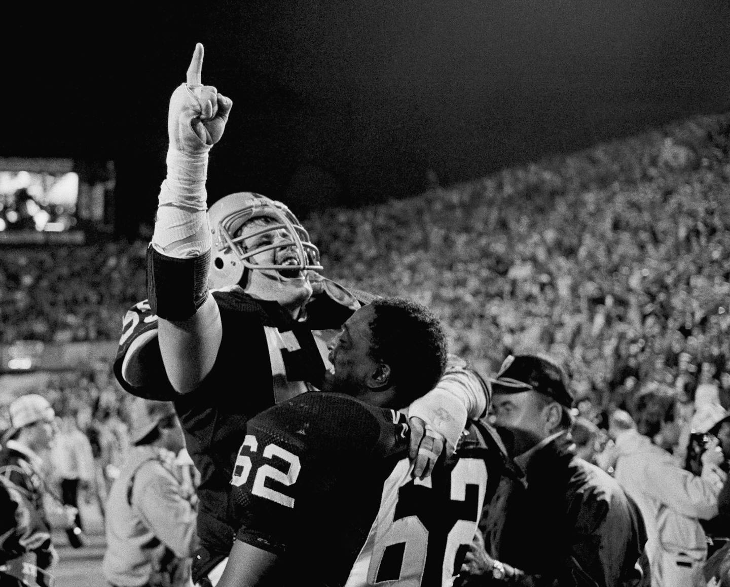 Los Angeles Raiders Matt Millen gives the number one sign as he celebrates with teammate Reggie Kinlaw following the Raiders 38-9 Win over the Washington redskins in Super Bowl XVIII, Sunday, Jan. 23, 1984, at Tampa Stadium. (AP Photo) ORG XMIT: APHS179182