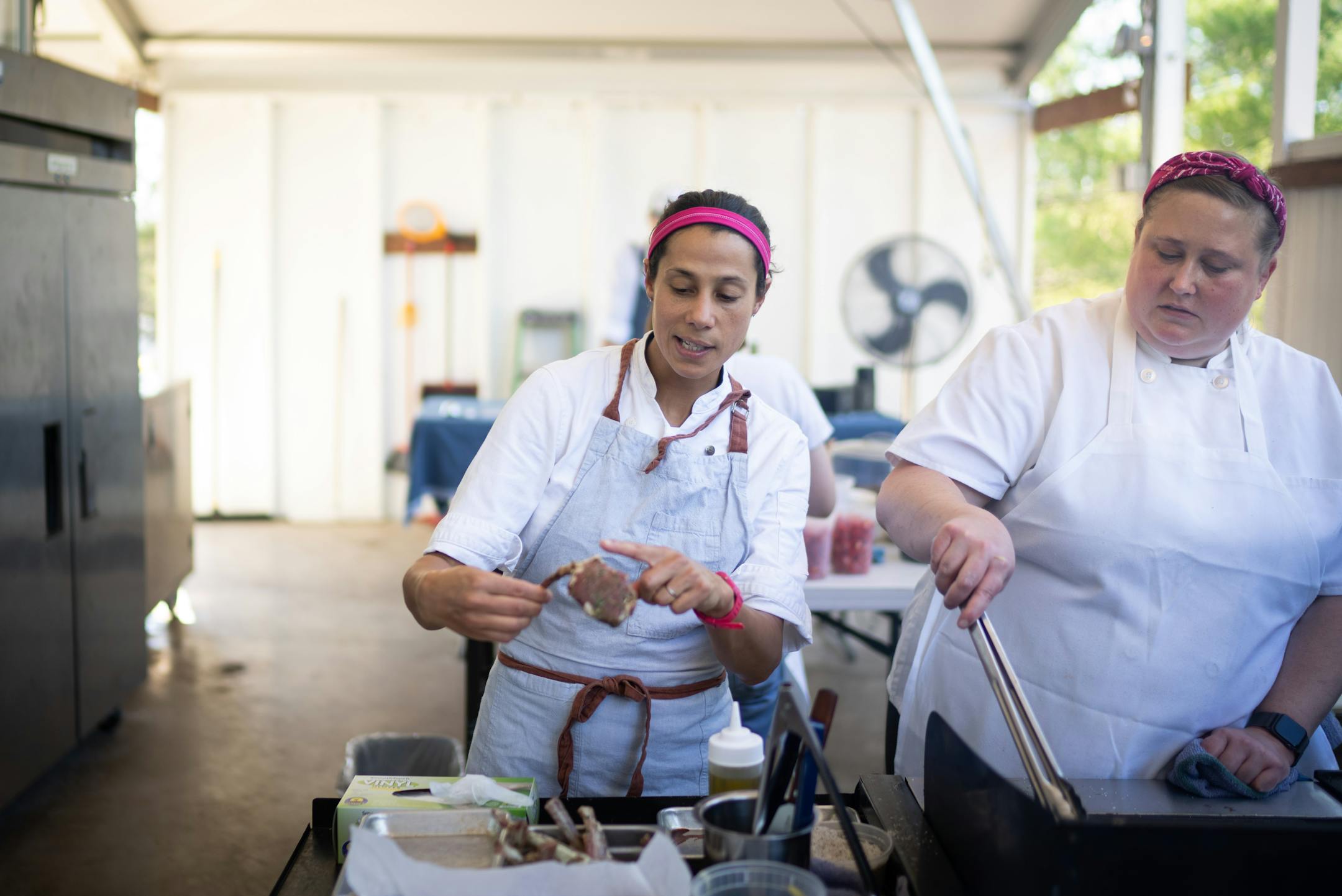 Chef Jo Seddon points out directions for cooking her lamb to Sarah Lee at Gia at the Lake.
