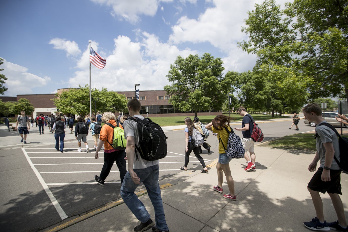 School districts across Minnesota are announcing their plans to reopen for the new year. Here, students walked between the portable classrooms and the main school building between the bell at Champlin Park High School in 2018.