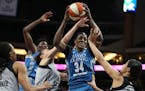 Lynx center Sylvia Fowles (34) pulled down a rebound over San Antonio forward Dearica Hamby left and Isabelle Harrison (20) on June 25