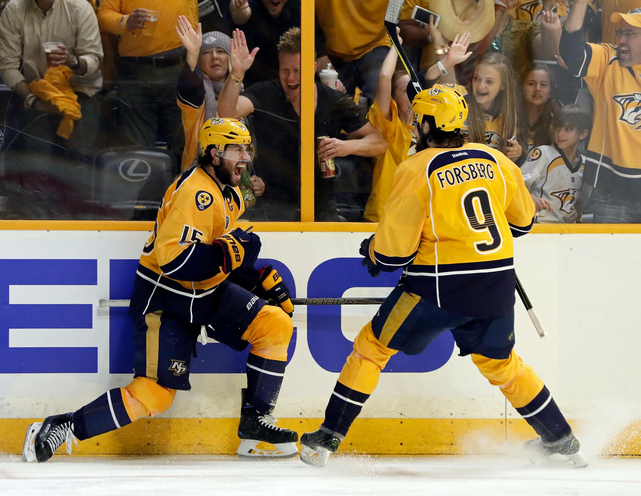 Nashville Predators right wing Craig Smith (15) celebrates his goal against the Pittsburgh Penguins with Filip Forsberg (9), of Sweden, during the third period in Game 3 of the NHL hockey Stanley Cup Finals Saturday, June 3, 2017, in Nashville, Tenn. (AP Photo/Mark Humphrey)