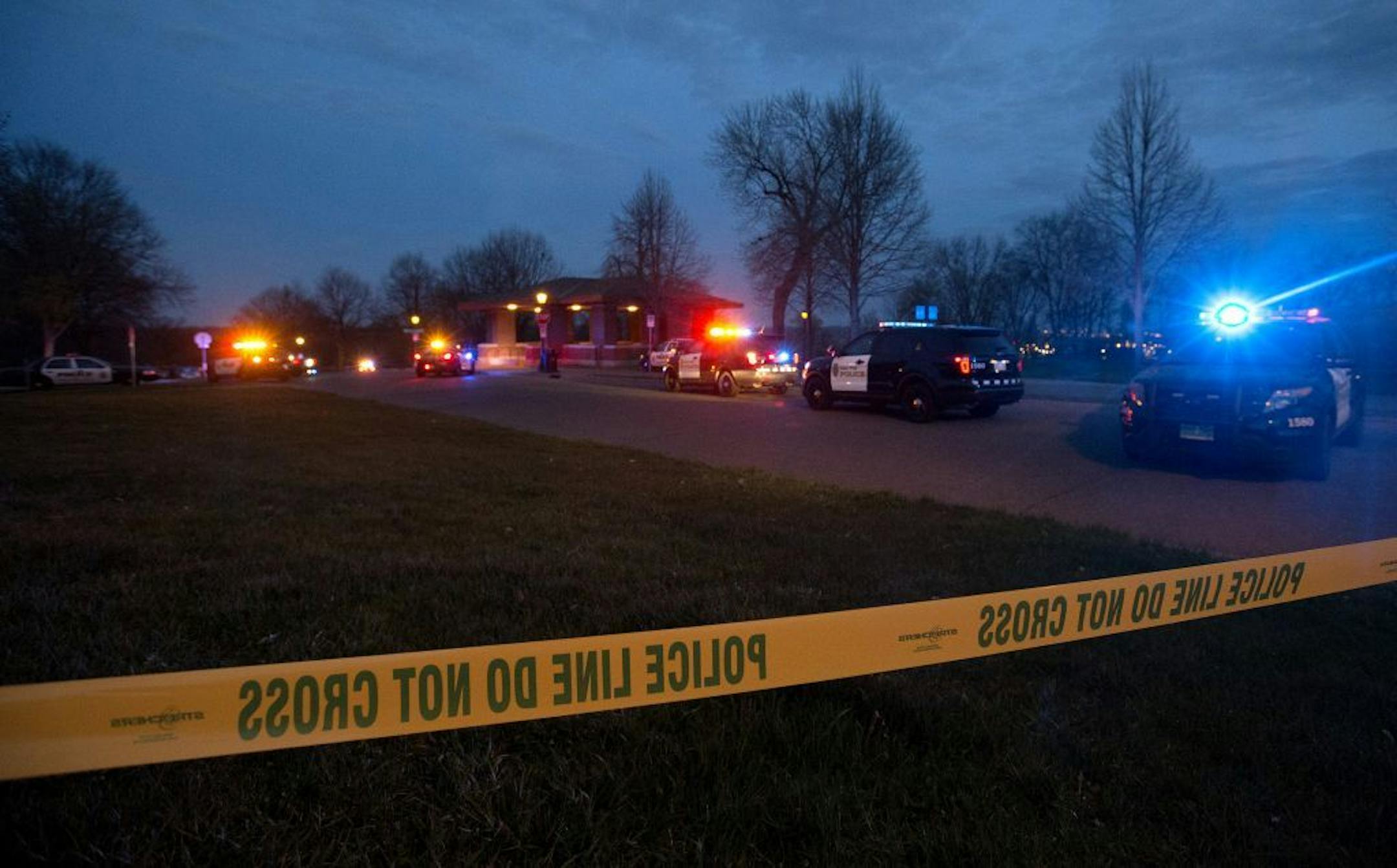 Police vehicles lined the street near a multiple shooting that took place at Indian Mounds Regional Park in St. Paul on Sunday night.