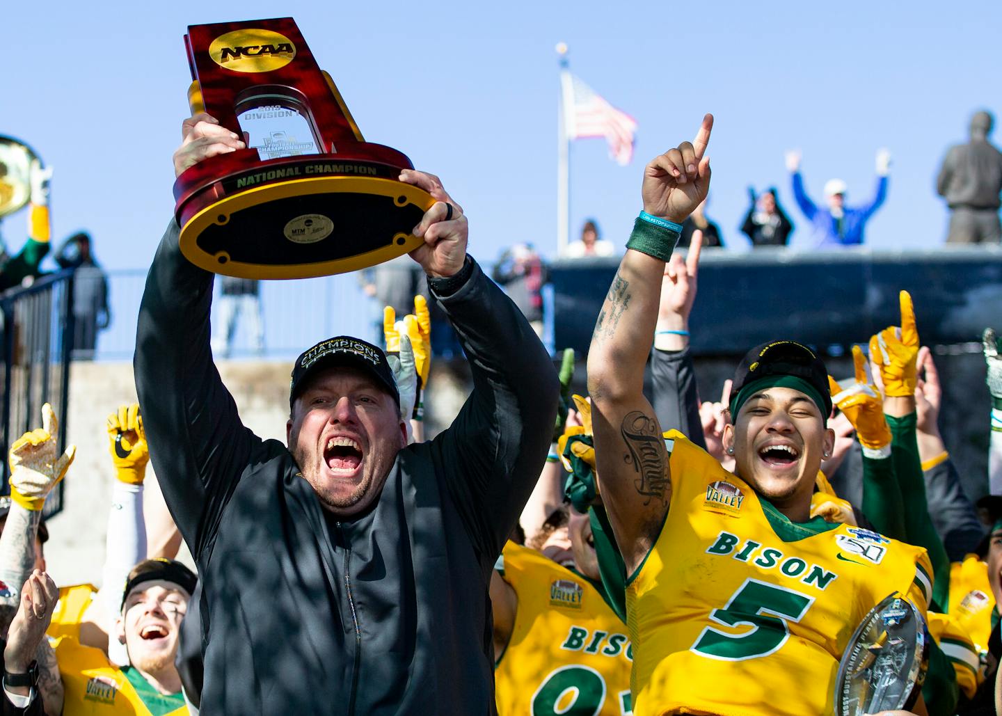 FILE - In this Jan. 11, 2020, file photo, North Dakota State head coach Matt Entz raises the trophy alongside quarterback Trey Lance (5) as they celebrate after beating James Madison 28-20 in the FCS championship NCAA college football game in Frisco, Texas. The Football Championship Subdivision season begins in earnest this weekend. With the fall season and playoffs, some of the top teams could play as many as two dozen games over a calendar year. Health experts say players face immense physical and mental challenges playing so many games.(AP Photo/Sam Hodde, File)