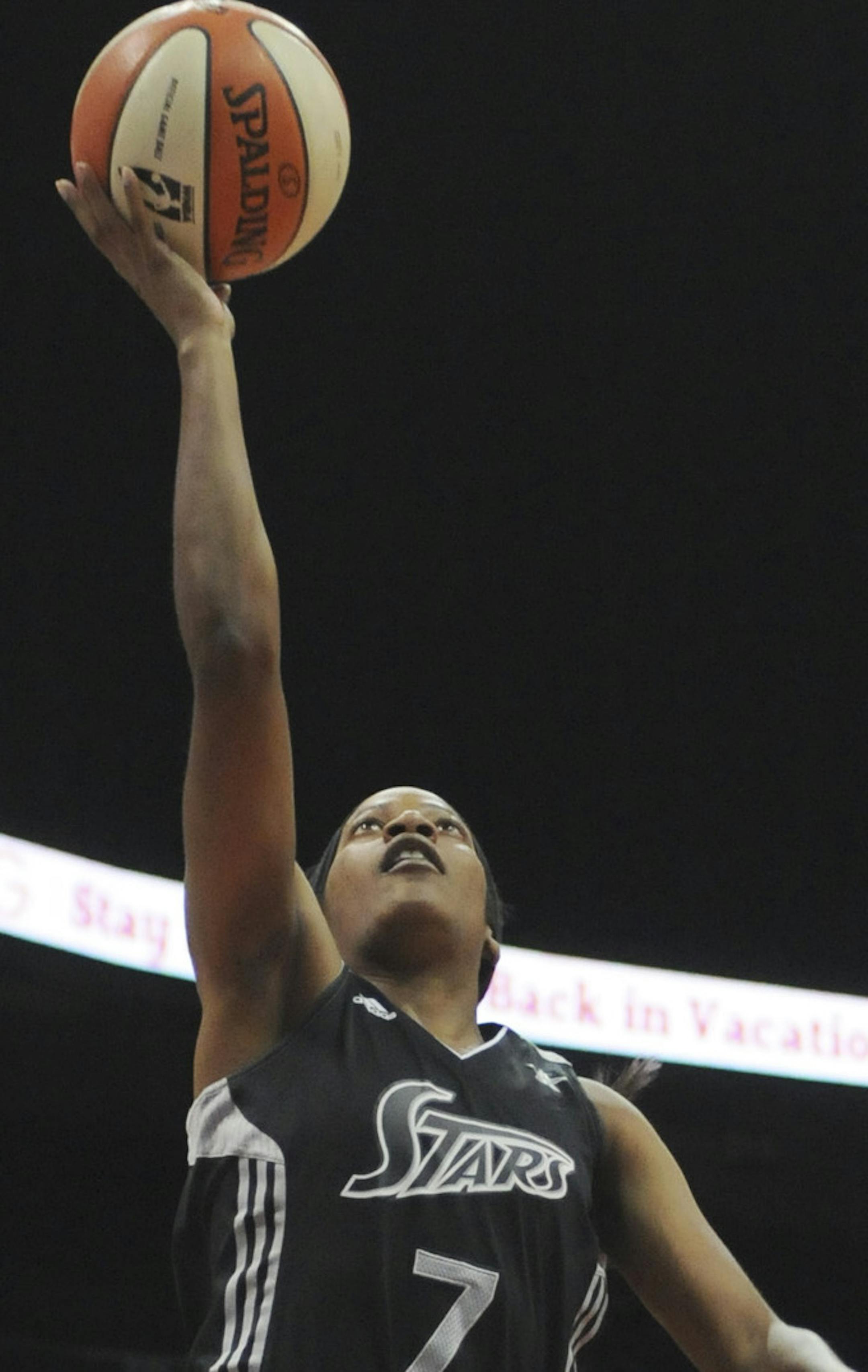 San Antonio Silver Stars guard Jia Perkins, left, shoots past Atlanta Dream center guard Iziane Castro Marques, center, and Alison Bales, right, in the first half of a WNBA basketball game, Sunday, June 26, 2011, in Atlanta. (AP Photo/Tami Chappell) ORG XMIT: GATC103