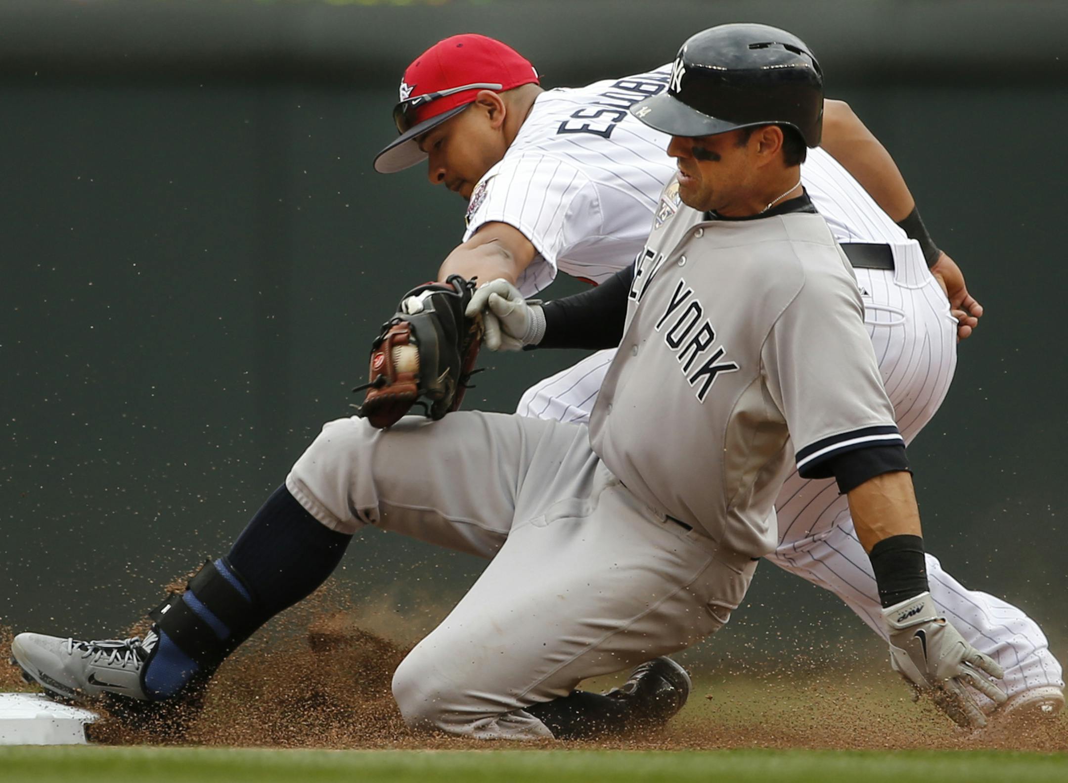 In the Twins game against the Yankees on July 4, 2014, Brian Roberts doubled to right and gets to second base safely in the top of the seventh before Eduardo Escobar(5) can apply the tag.] rtsong-taatarii@startribune.com