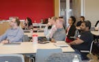 University of Minnesota students and Target leaders at Target's Brooklyn Park campus listen to student presentations for a U capstone course. (Provide