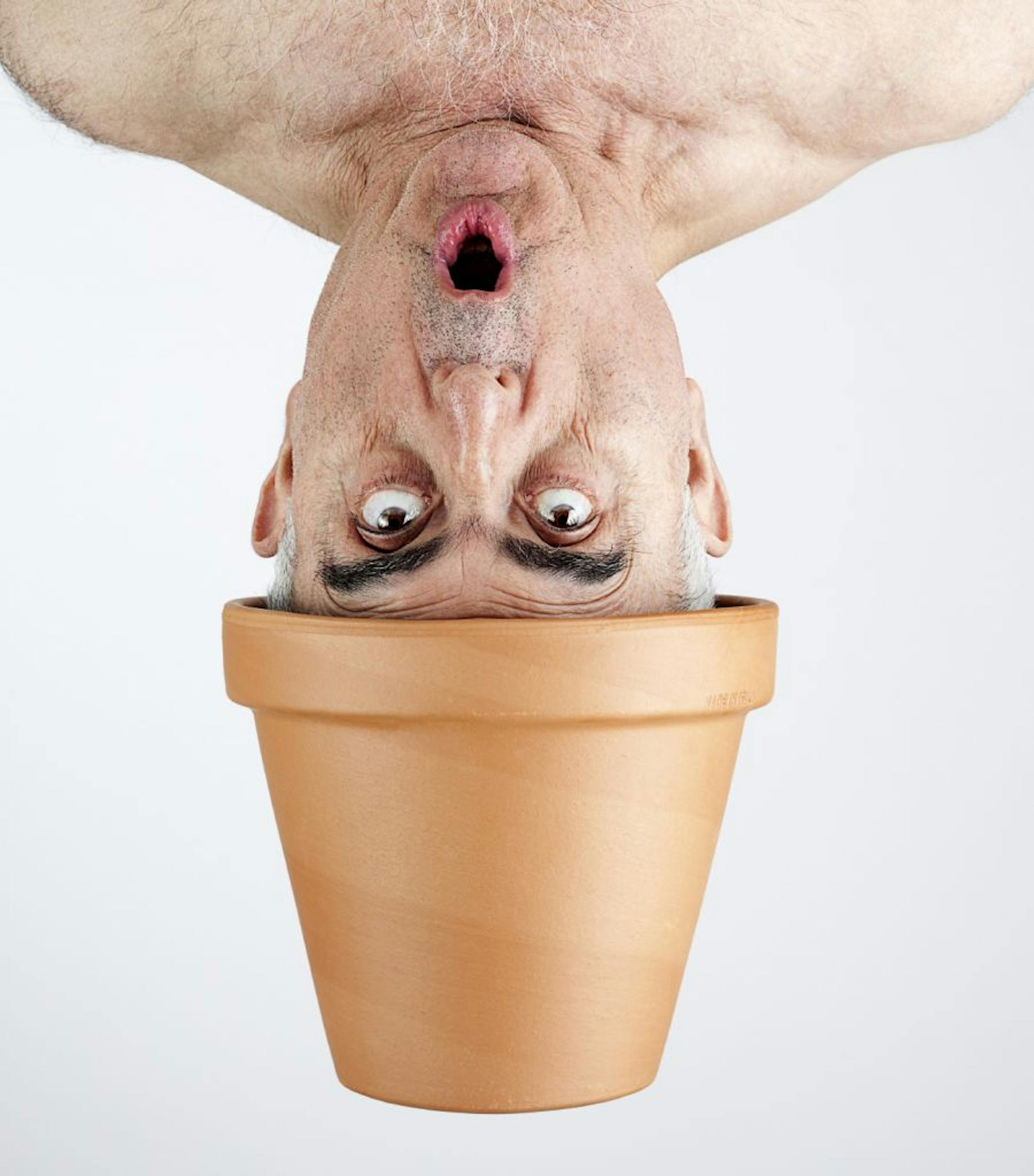 ISTOCKPHOTO.COM naked gardening photo illustration, nude man with clay flower pot on his head