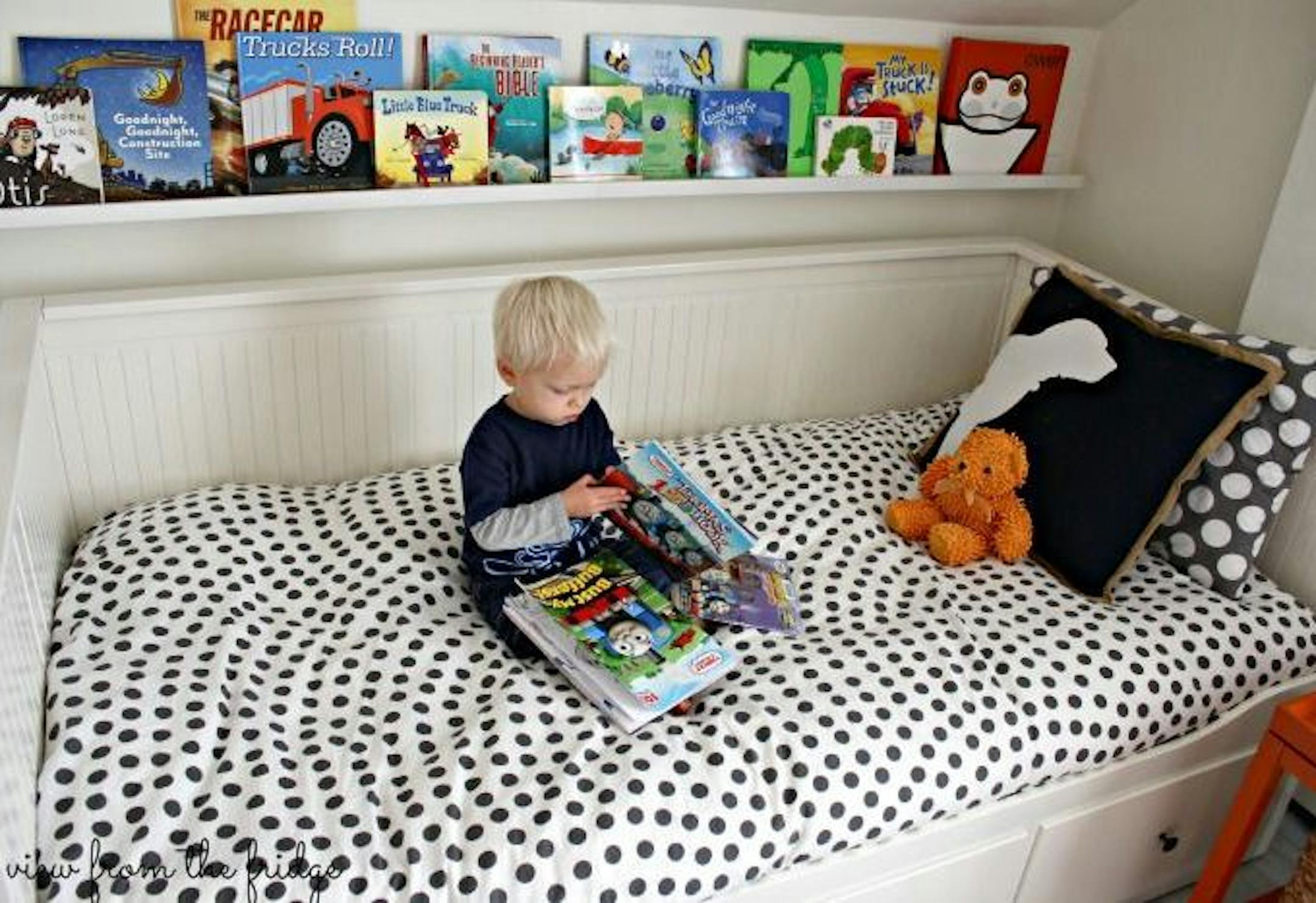 Charlie Stahl looks at a book in the room he shares with his brother.