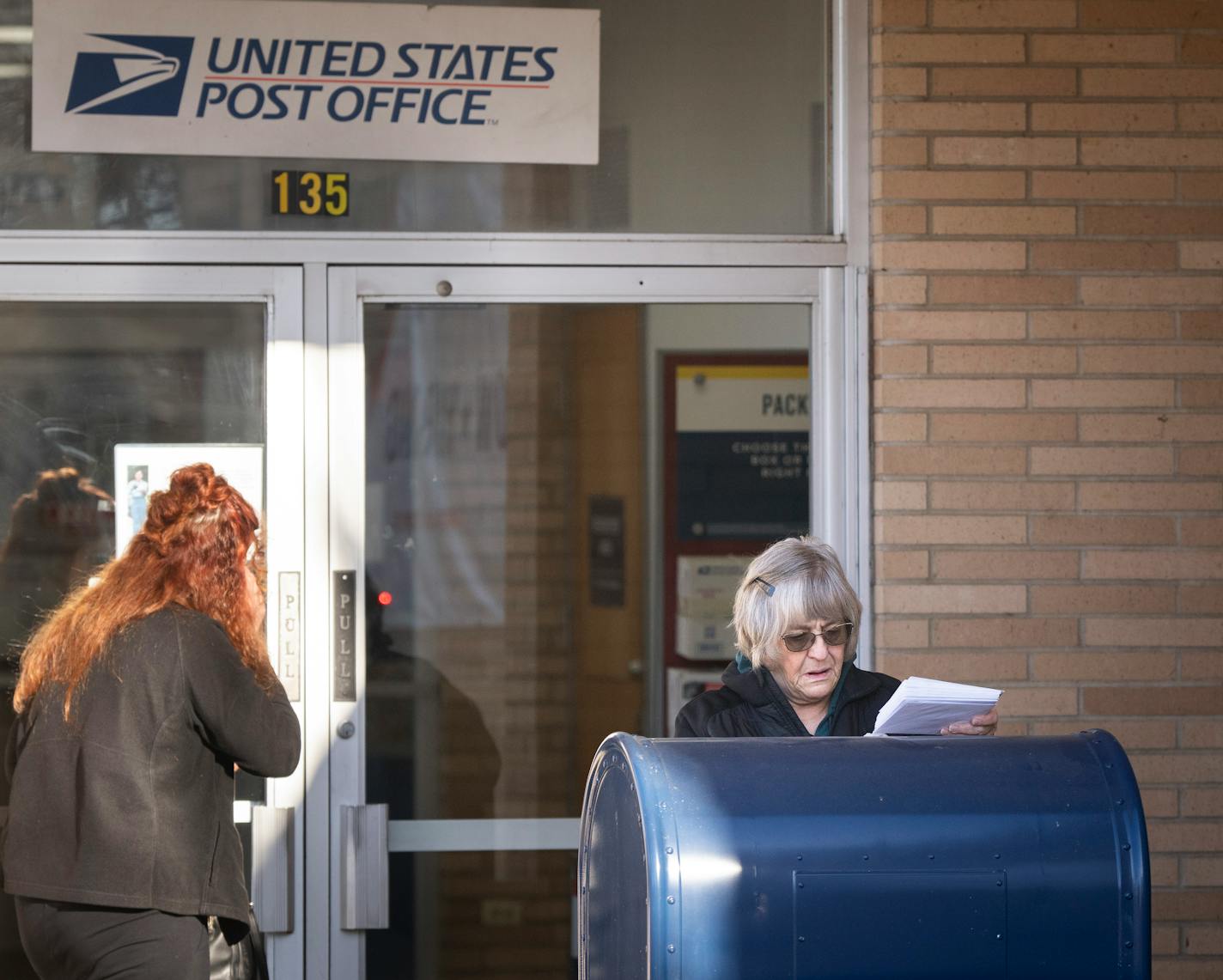 Diana Martinek mails bills and Christmas cards at the U.S Post Office on Thursday, Dec. 7, 2023 in downtown Shakopee, Minn. ] RENEE JONES SCHNEIDER • renee.jones@startribune.com