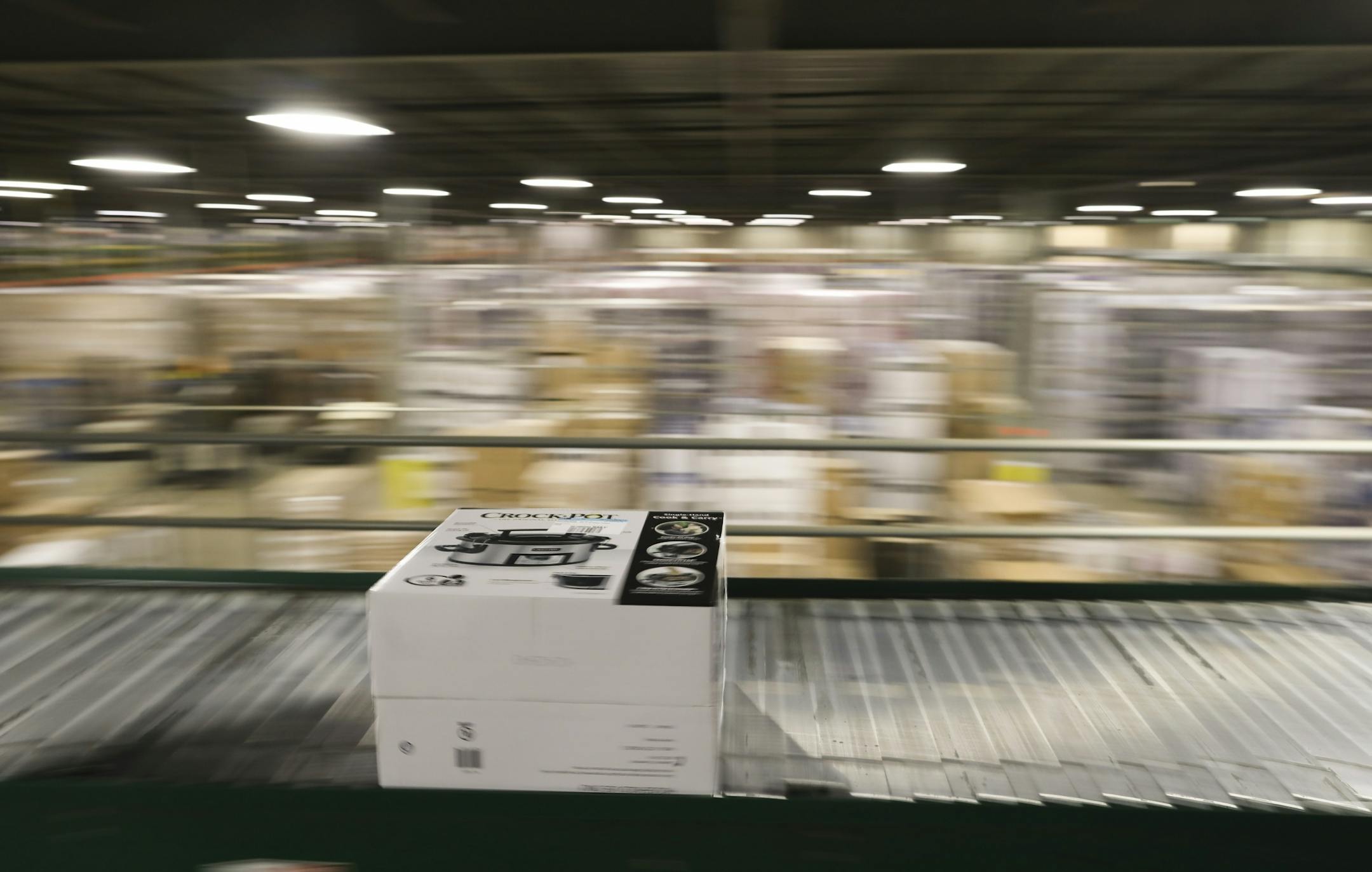 A crock pot moved along a conveyer belt towards a scanner that will direct it to the appropriate trailer for shipping from the Best Buy distribution center in Bloomington.