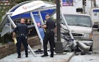 Police look over the scene where a van slammed into a crowded bus stop shelter in north Minneapolis on July 9. George Reeves Jensen of Champlin, who c
