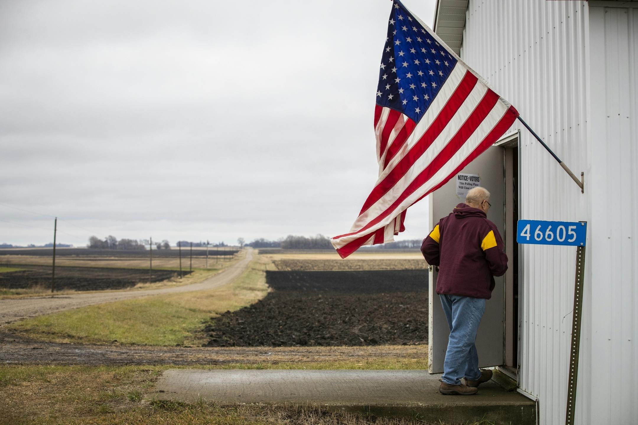 David Kahle walks into Sibley Town Hall on Election Day. Kahle, a farmer and township clerk, voted, but also baked cookies for all the voters and election officials.