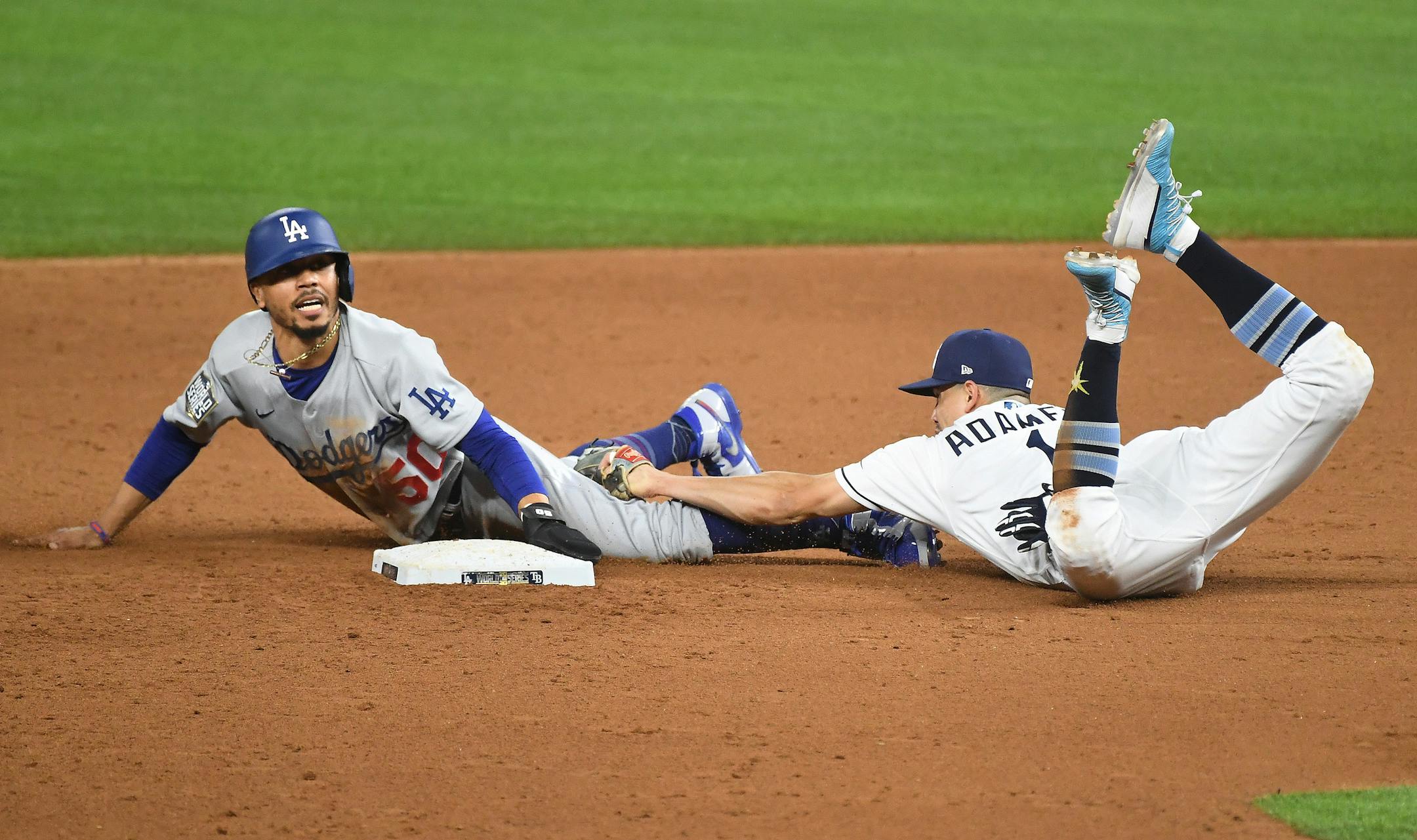 Los Angeles Dodgers' Mookie Betts steals second base in front of Tampa Bay Rays shortstop Willy Adames in the sixth inning in Game 3 of the World Series