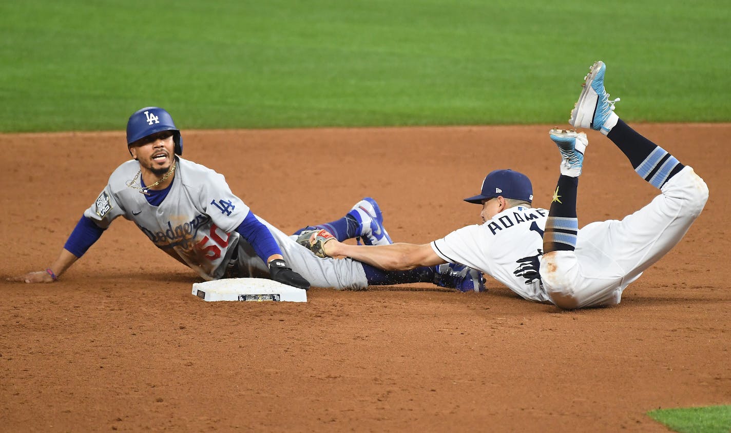 Los Angeles Dodgers' Mookie Betts steals second base in front of Tampa Bay Rays shortstop Willy Adames in the sixth inning in Game 3 of the World Series