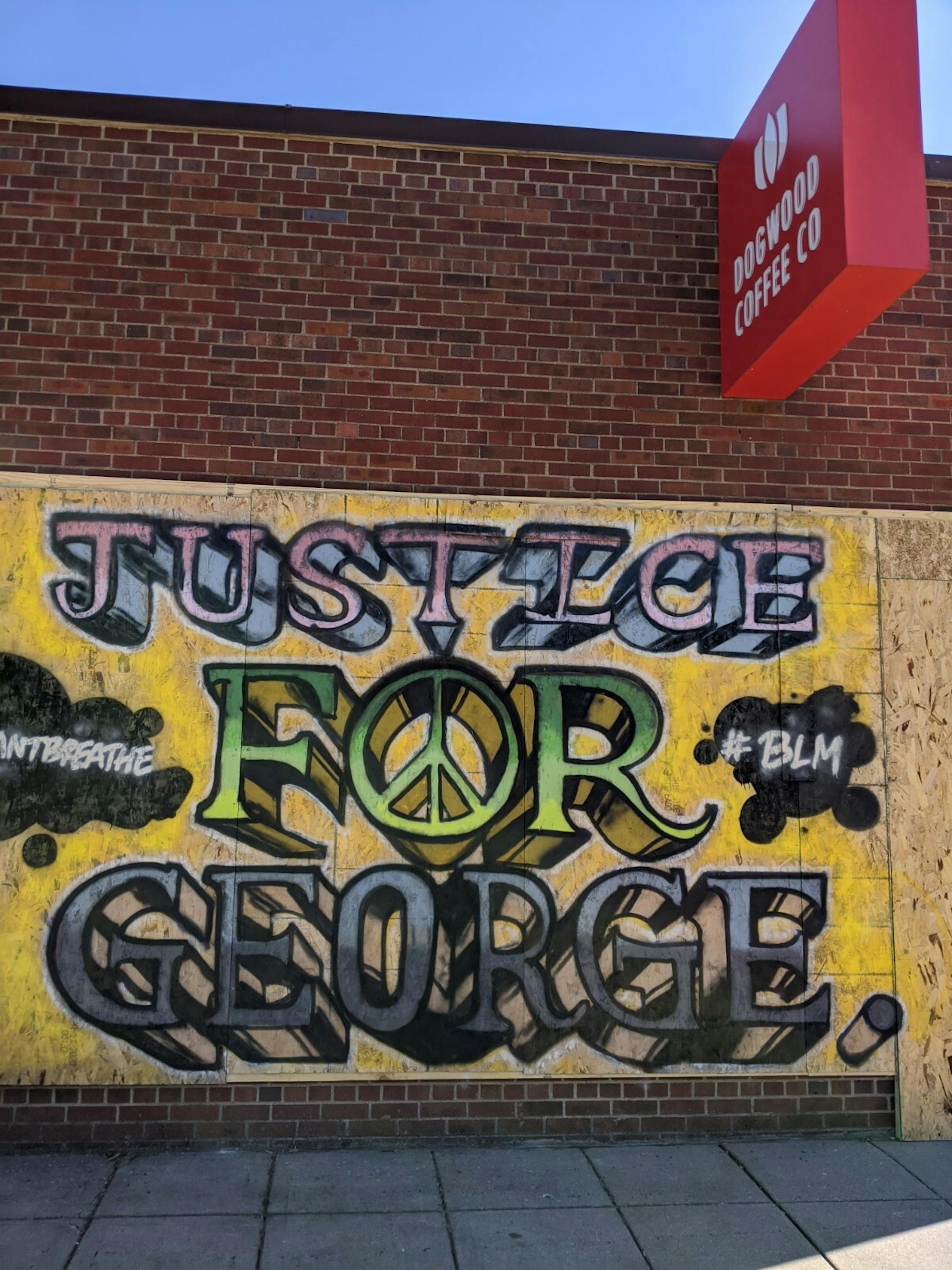 In a mural on Dogwood Coffee Bar at 4021 E Lake St. incorporates a peace sign, the Black Lives Matter hashtag, and several of George Floyd's final words.