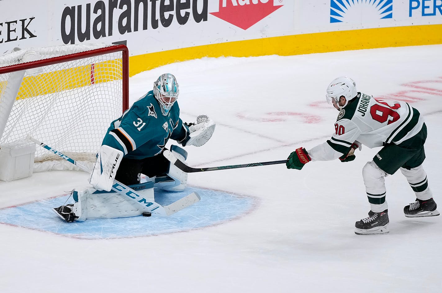 San Jose Sharks goaltender Martin Jones (31) blocks a shot by Minnesota Wild center Marcus Johansson (90) during a shootout in an NHL hockey game in San Jose, Calif., Monday, March 29, 2021. San Jose won 3-2 in the shootout. (AP Photo/Tony Avelar)