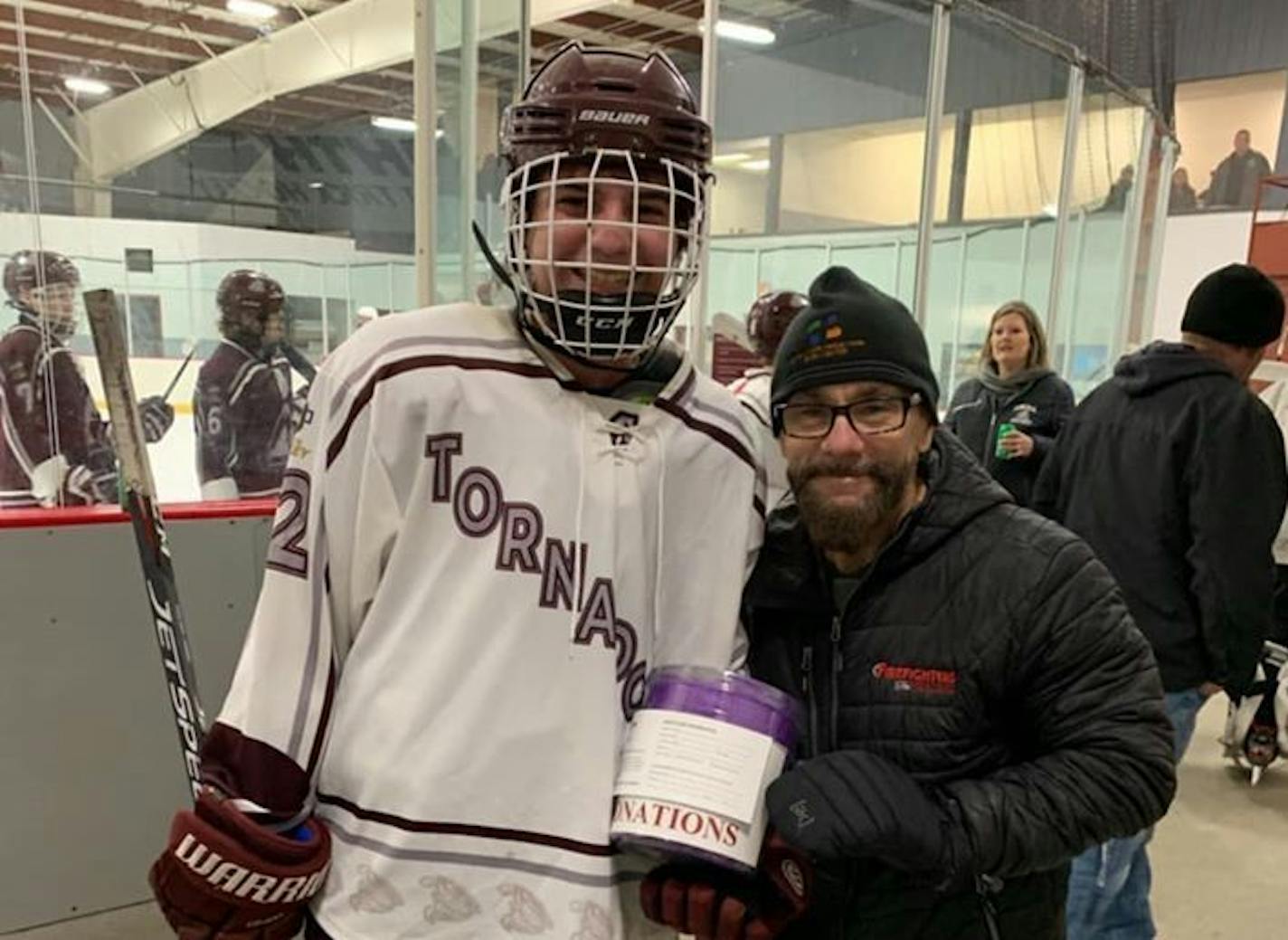 Anoka hockey player Sam Hanks, 15, met Jake LaFerriere, right, after he healed from severe burns.