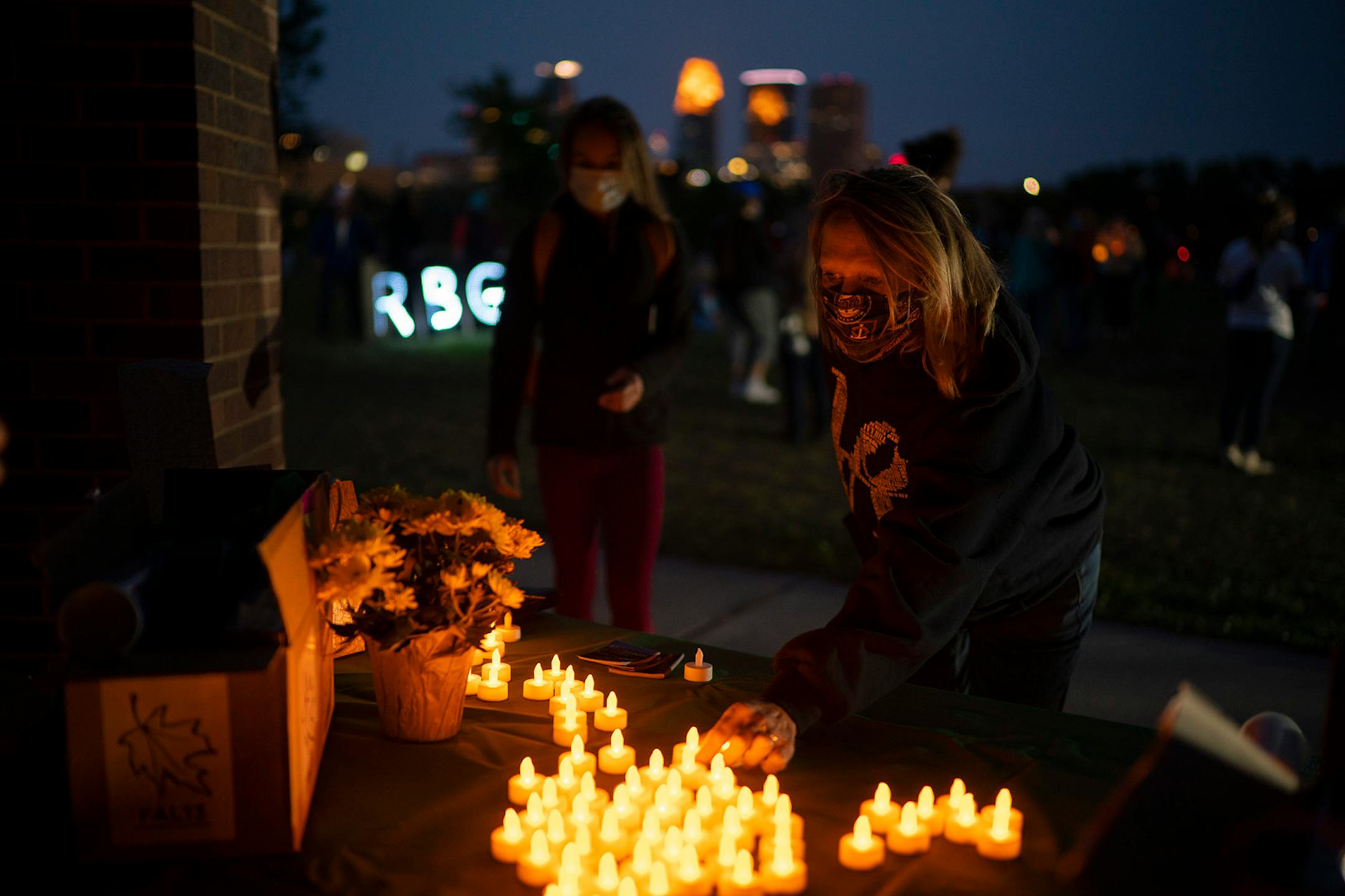 People picked up electric candles from a table before the program began.