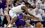 Anthony Edwards (5) of the Minnesota Timberwolves and Bradley Beal (3) of the Phoenix Suns fight for the ball in the first quarter Tuesday.