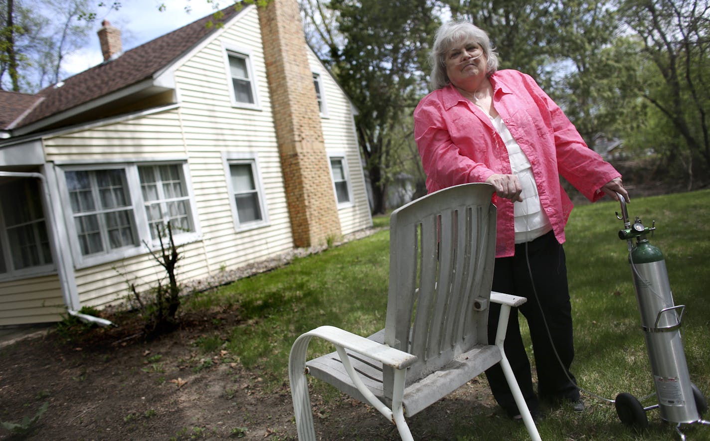 Sharon Torberg stood in the side yard of her home where she raised her two kids and made 30 years of memories in Minnetonka, Min., Thursday, May 16, 2013. Torberg lost her job, has a chronic illness and now is two months behind on her mortgage payment. ] (KYNDELL HARKNESS/STAR TRIBUNE) kyndell.harkness@startribune.com