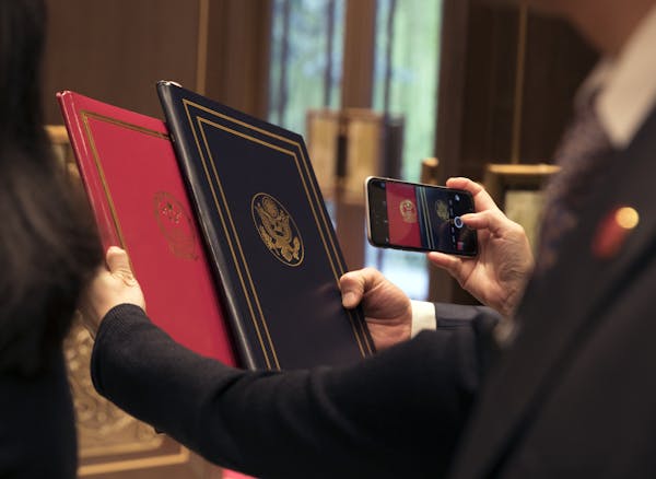 FILE &#x2014; Folders with the seals of People&#x2019;s Republic of China and the United States at a summit where the two nations formally committed t