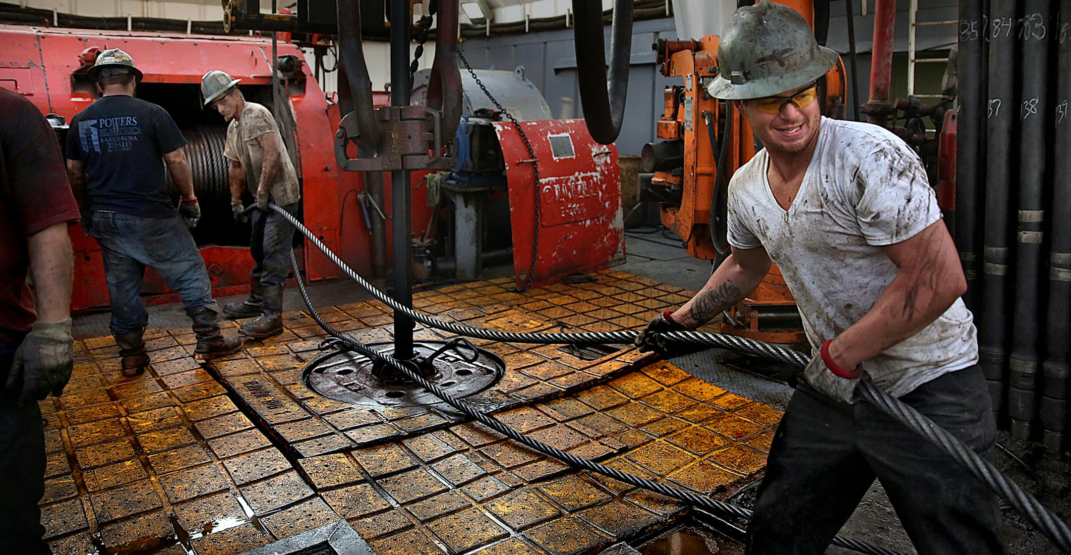 Floor hand Russell Girsh (right) guided into place before drilling began. ] (JIM GEHRZ/STAR TRIBUNE) / December 17, 2013, Watford City, ND ‚Äì BACKGROUND INFORMATION- PHOTOS FOR USE IN FINAL PART OF NORTH DAKOTA OIL BOOM PROJECT: Men work around the clock at Raven Rig No. 1 near Watford City, one of nearly 200 towering oil rigs in the Bakken. Once the rigs drill holes, several miles deep and then several miles horizontally, hydraulic fracturing technology (‚Äúfr