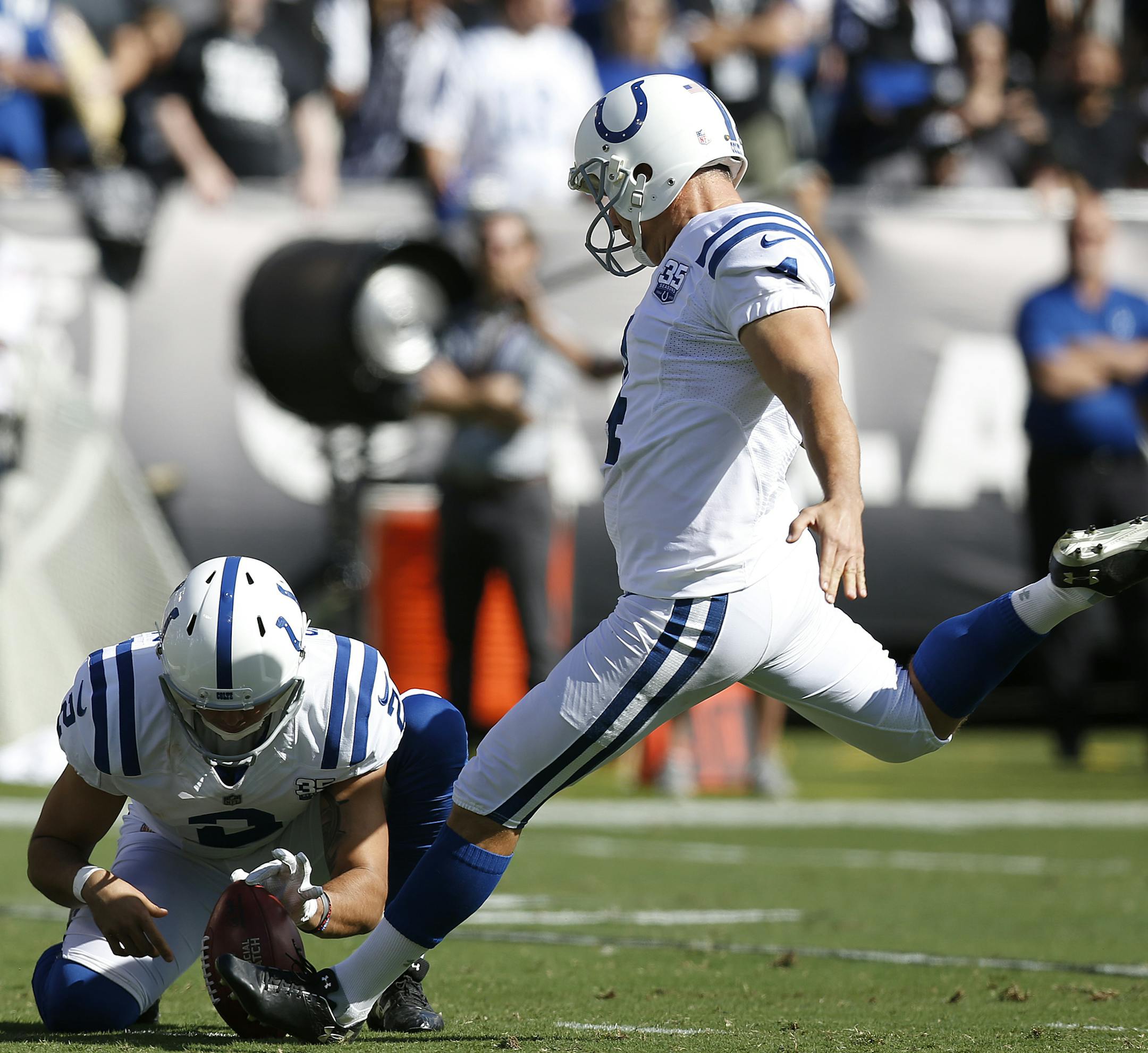 Indianapolis Colts kicker Adam Vinatieri, right, kicks a field goal from the hold of Rigoberto Sanchez against the Oakland Raiders during the first half of an NFL football game in Oakland, Calif., Sunday, Oct. 28, 2018. Vinatieri tied Morten Andersen's NFL record for points with this kick. (AP Photo/D. Ross Cameron)