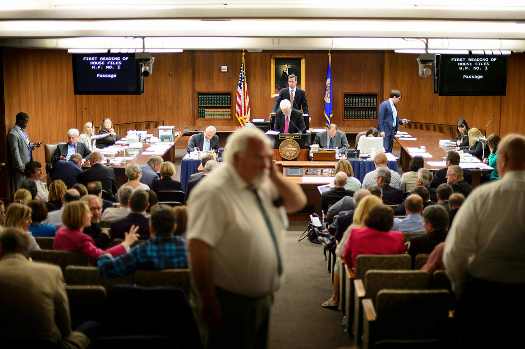 The temporary House Chamber in the State Office Building was small warm and close.