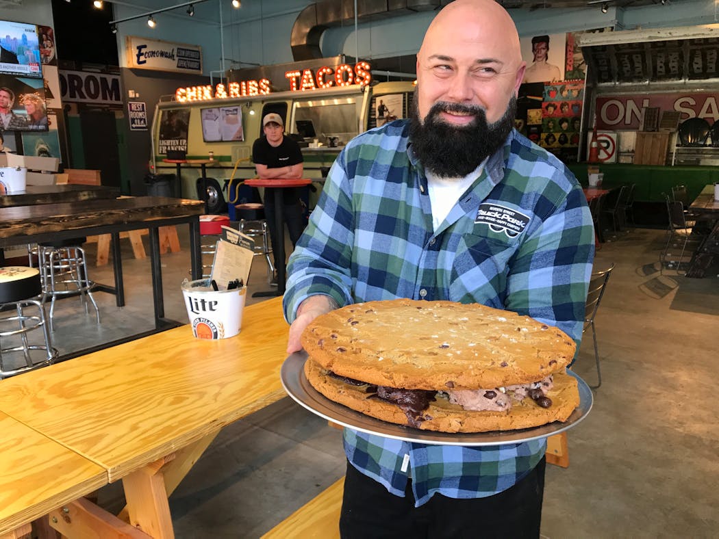 Brian Ingram, owner of Truck Park, holds one of his giant ice cream sandwiches.