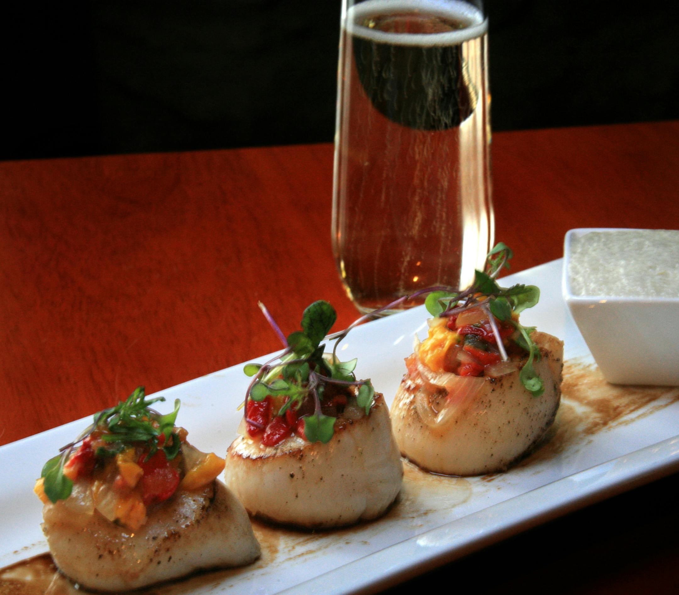 Chef Patrick Antanalian brings color into the the menu with his scallops with smoked ratatouille, sunchoke silk foam and balsamic paint at Sanctuary.