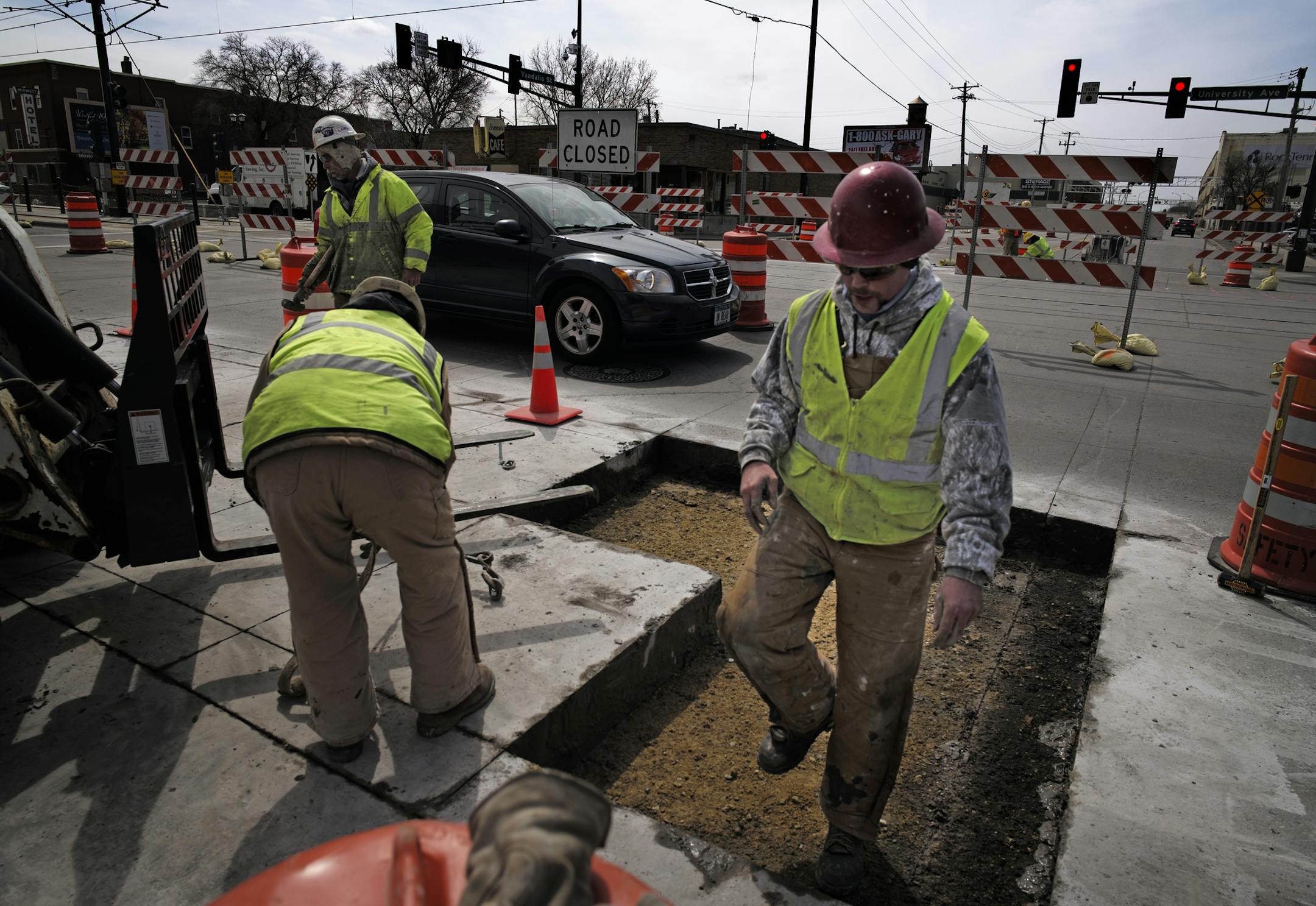 At the corner of Vandalia Street and University Avenue, construction workers cut and removed slabs of concrete near the Green line of the LRT because it was faulty.