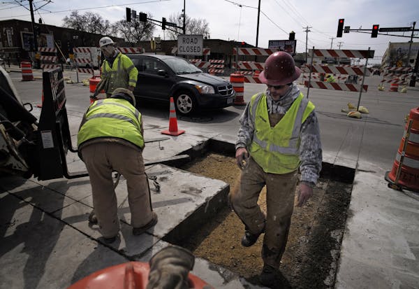 At the corner of Vandalia Street and University Avenue, construction workers cut and removed slabs of concrete near the Green line of the LRT because 