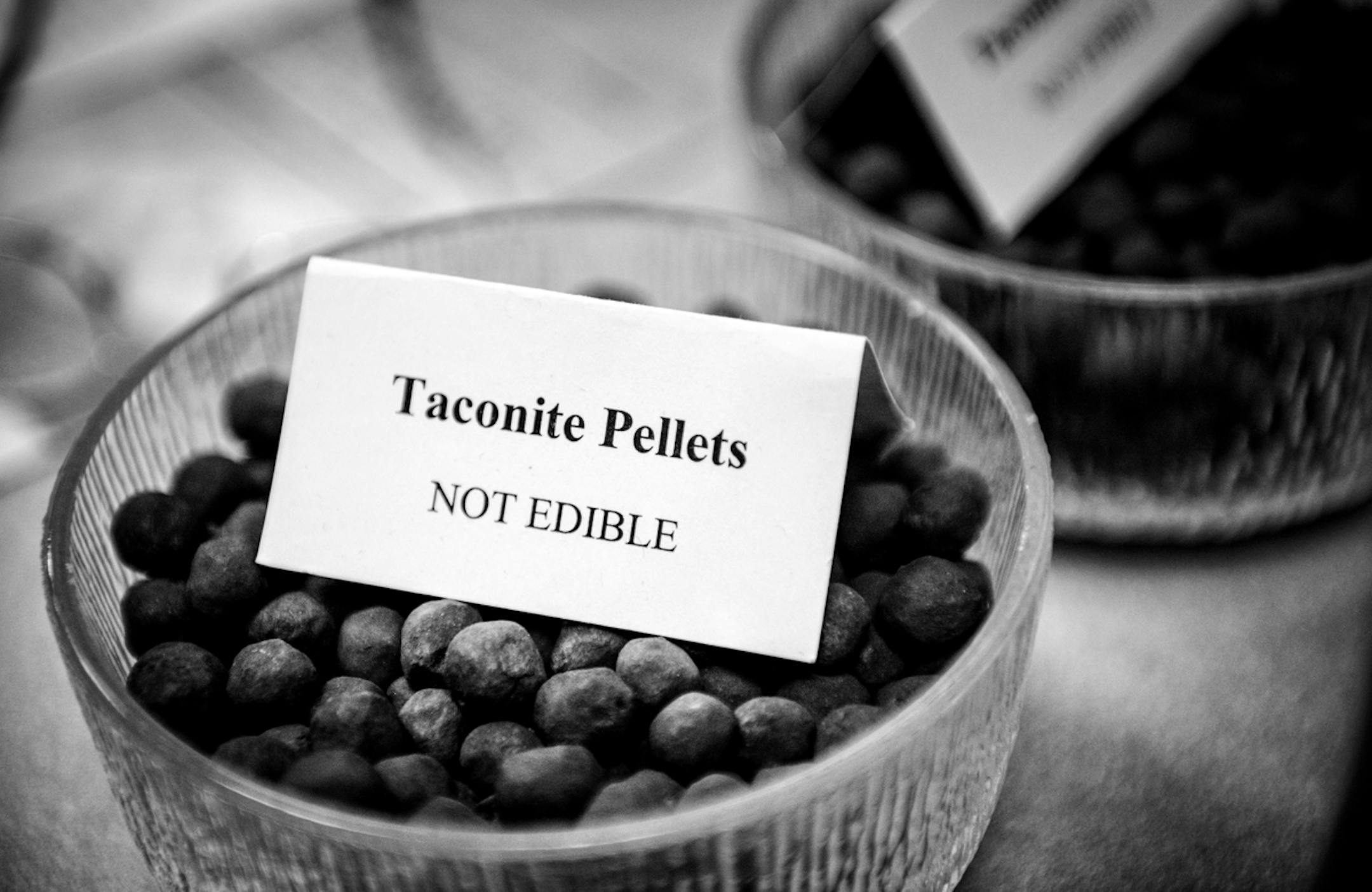 A sign on a bowl of Taconite pellets in Senate Majority Leader Tom Bakk's office warns people not to eat them but he said people still try. Bakk is from the Iron Range where taconite mining plays a major economic role. ] GLEN STUBBE * gstubbe@startribune.com Monday, March 31, 2014.