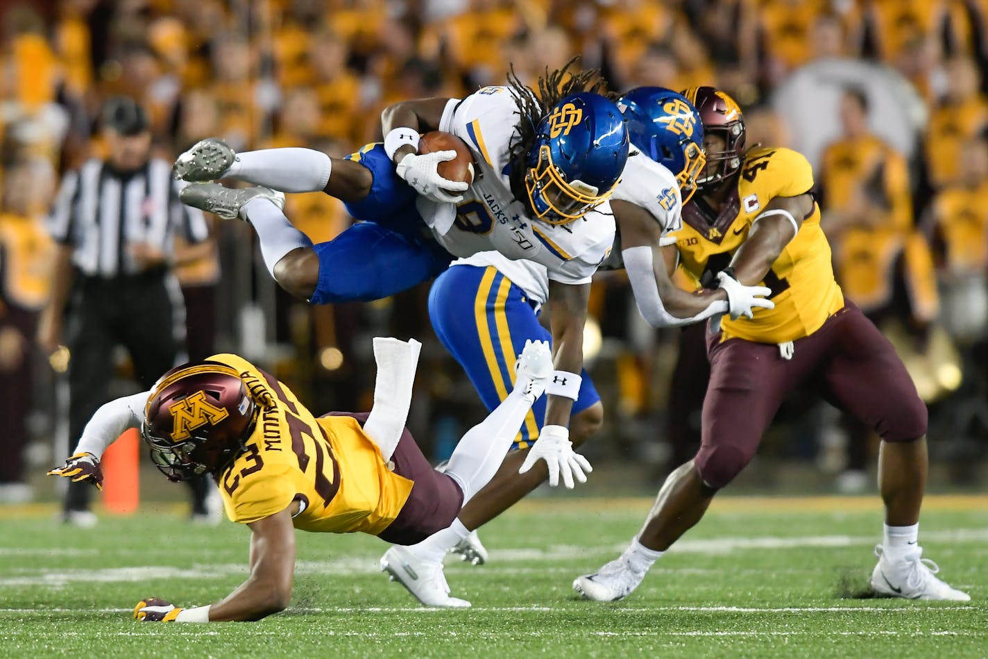 South Dakota State running back C.J. Wilson was tackled by Gophers defensive back Jordan Howden