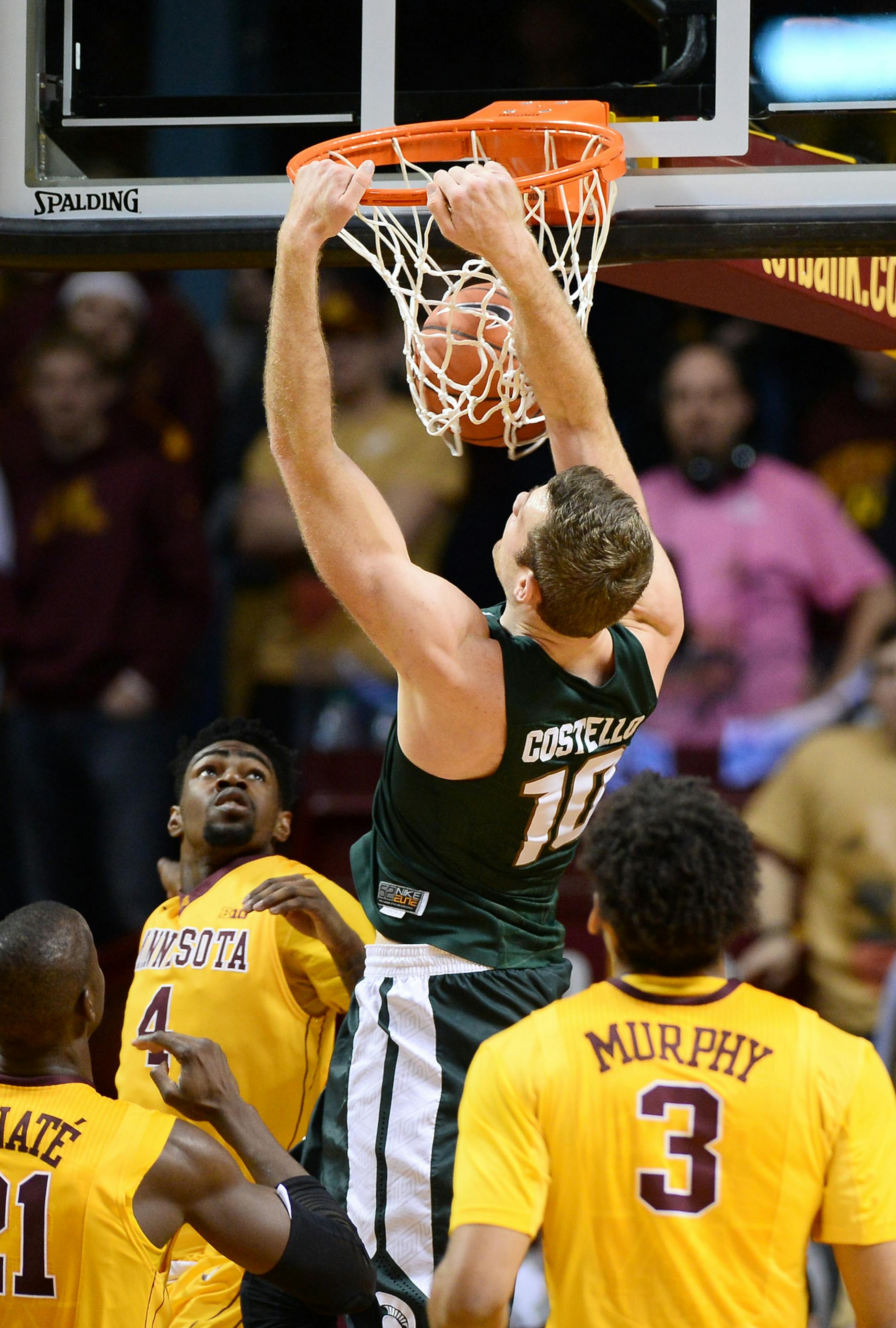 Michigan State Spartans forward Matt Costello (10) dunked over a host of Minnesota defenders in the second half Saturday. ] (AARON LAVINSKY/STAR TRIBUNE) aaron.lavinsky@startribune.com The University of Minnesota Golden Gophers men's basketball team played the Michigan State Spartans on Saturday, Jan. 2, 2016 at Williams Arena in Minneapolis, Minn.