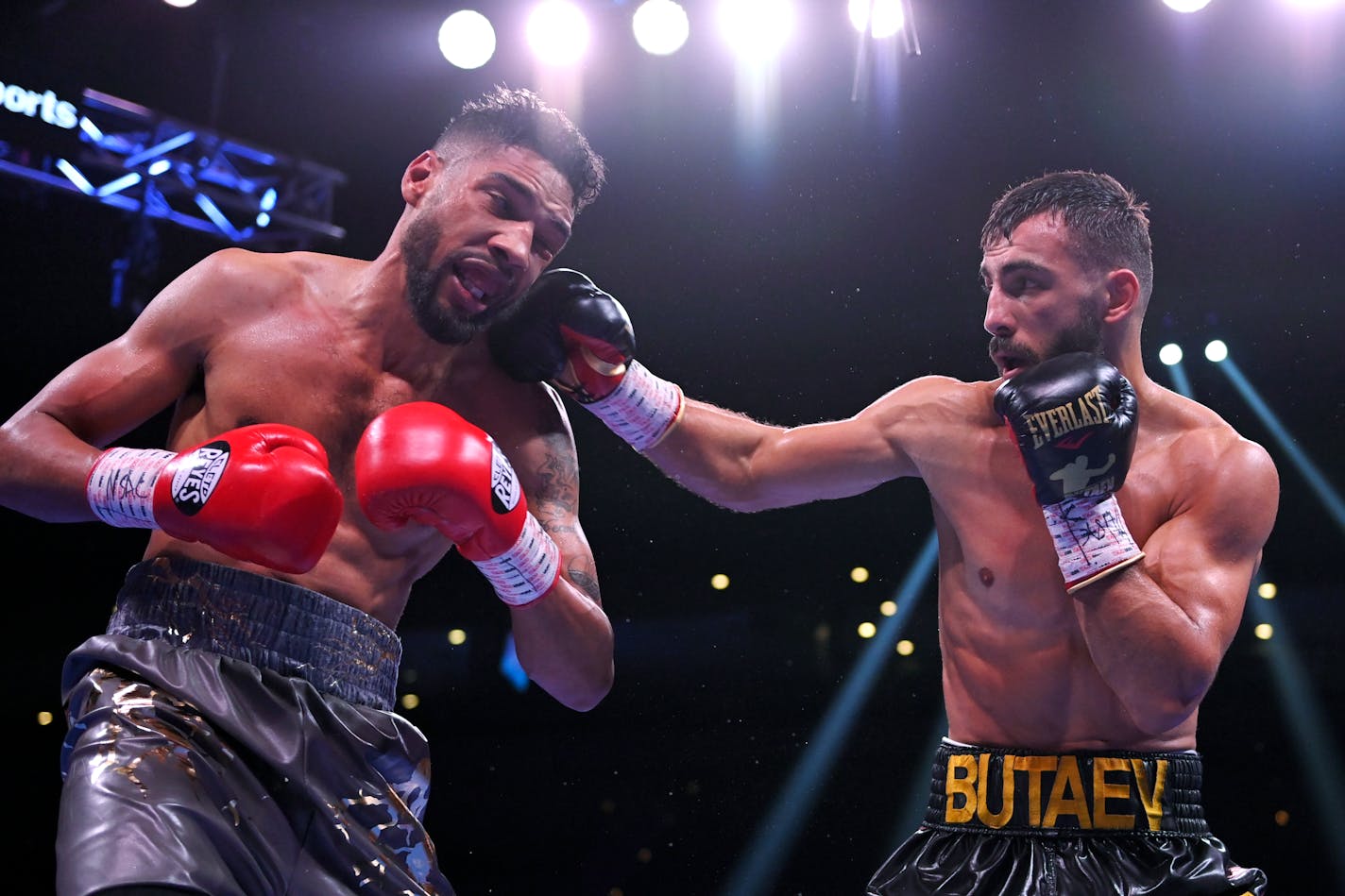 Radzhab Butaev, right, of Russia, punches Jamal James during a WBA welterweight title boxing match Saturday, Oct. 30, 2021, in Las Vegas. (AP Photo/David Becker)