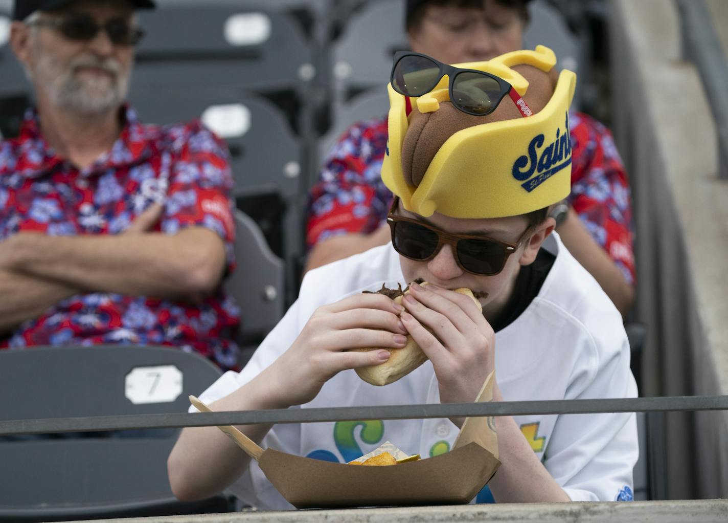 Justin Henry ate his dinner in his Saints hot dog hat during the St. Paul Saints home opener at CHS field in St. Paul, Minn., on Thursday, May 16, 2019. ] RENEE JONES SCHNEIDER &#xa5; renee.jones@startribune.com