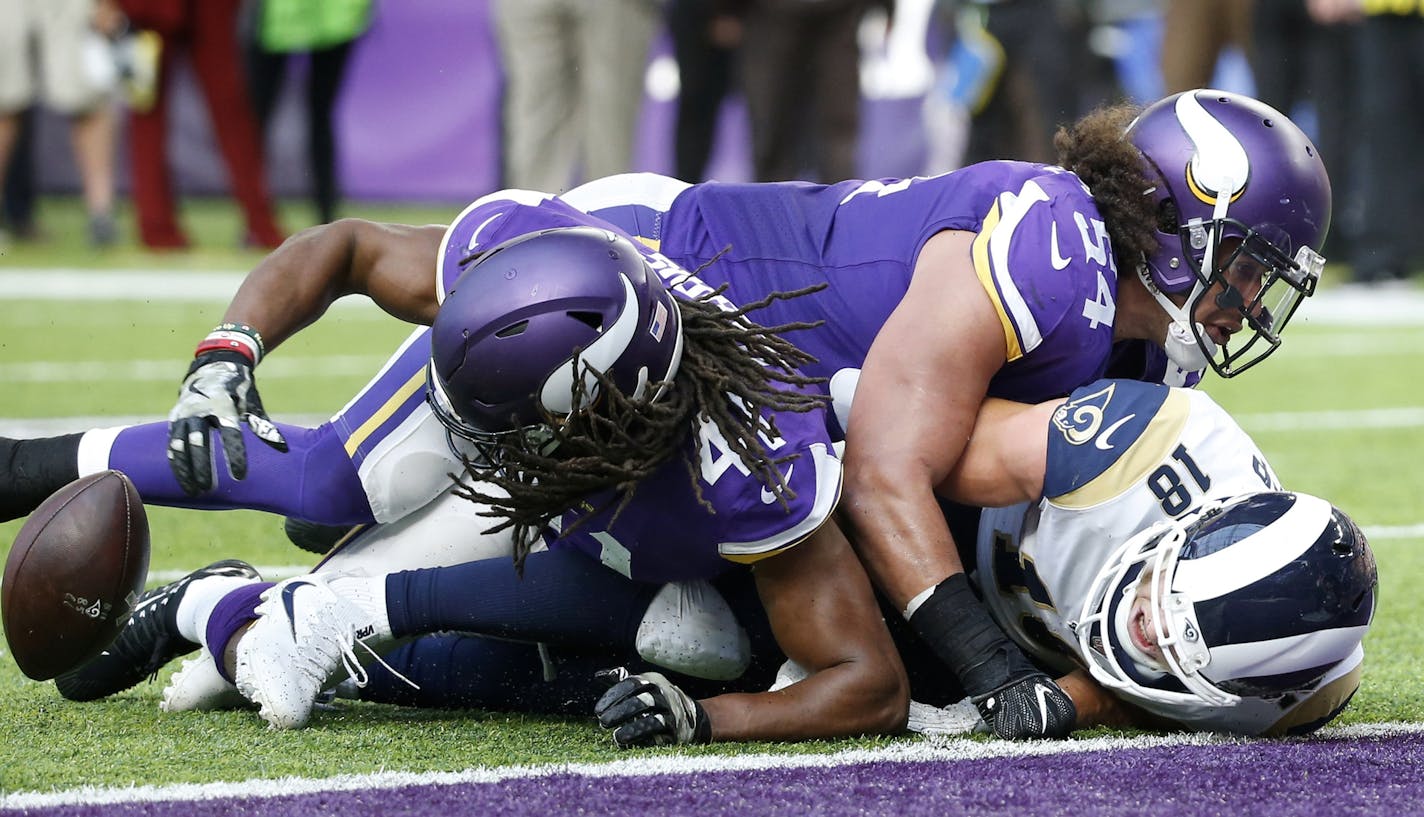 Minnesota Vikings strong safety Anthony Harris, left, recovers a fumble by Los Angeles Rams wide receiver Cooper Kupp (18) during the first half of an NFL football game, Sunday, Nov. 19, 2017, in Minneapolis. (