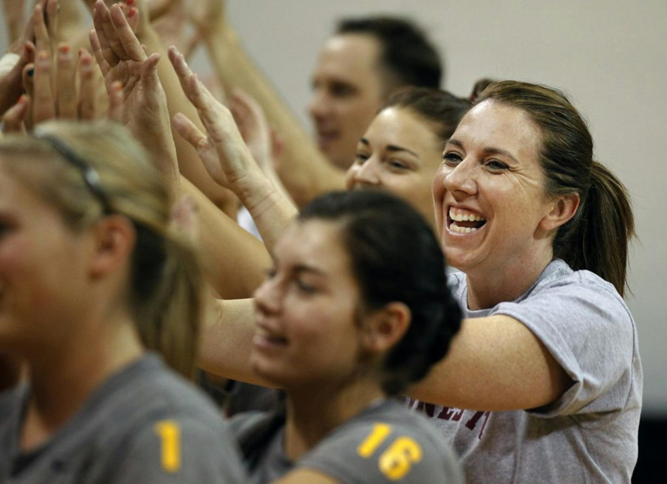 Interim coach Laura Bush, right, knows she will run the program for one season before Hugh McCutcheon takes over.